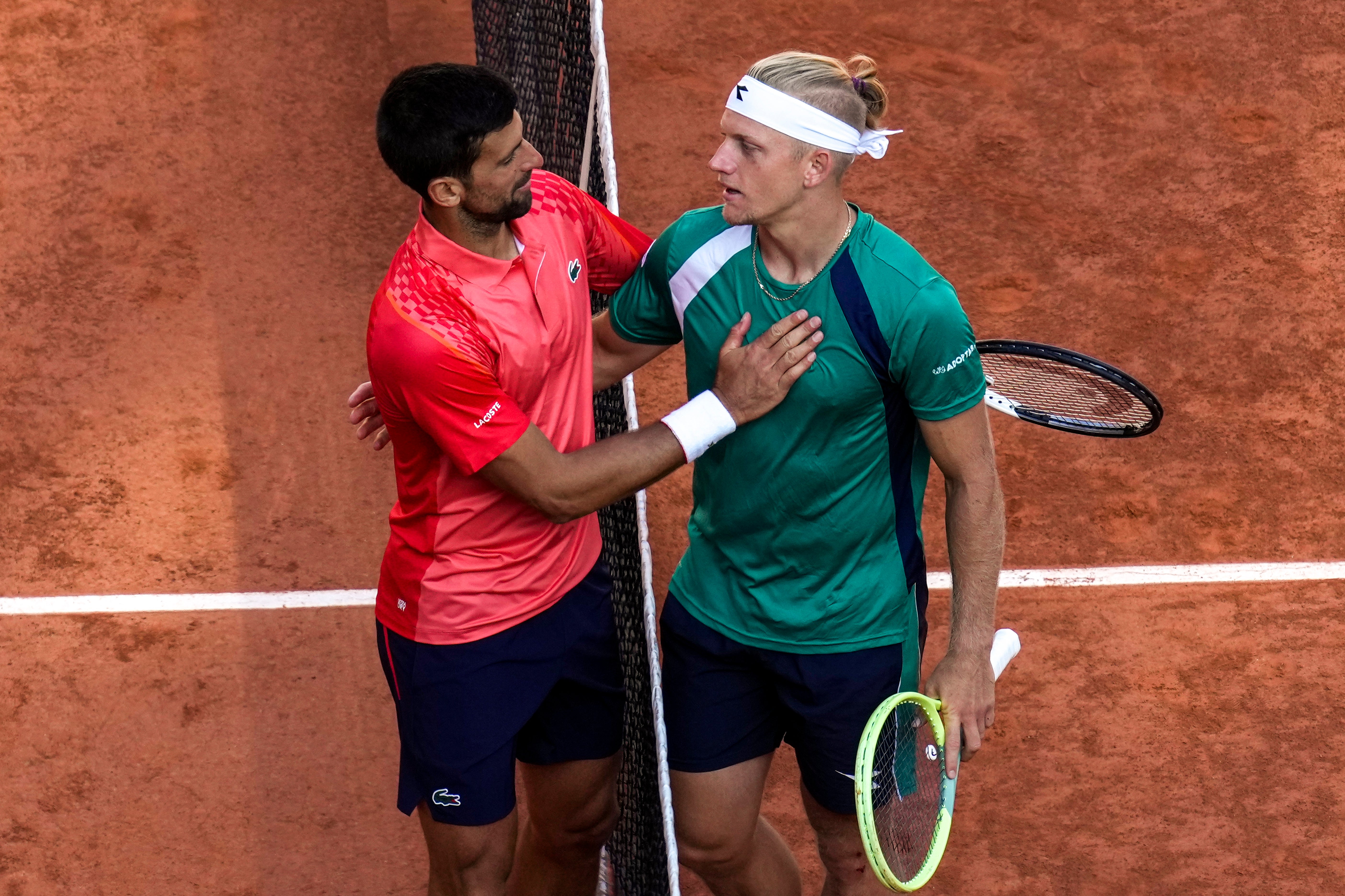 Novak Djokovic is congratulated by Spain’s Alejandro Davidovich Fokina