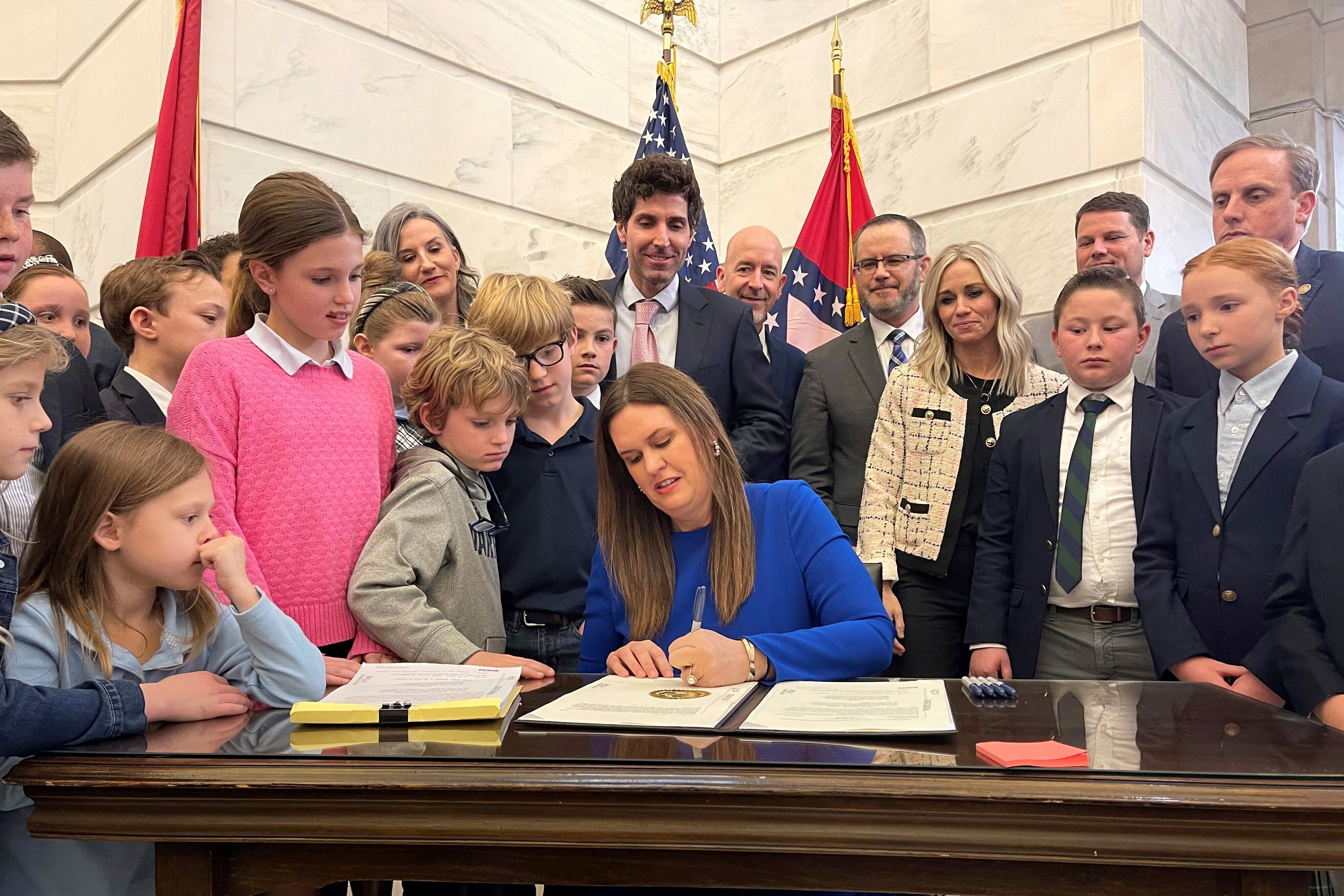 Arkansas Governor Sarah Huckabee Sanders is pictured signing an education overhal bill in March 2023