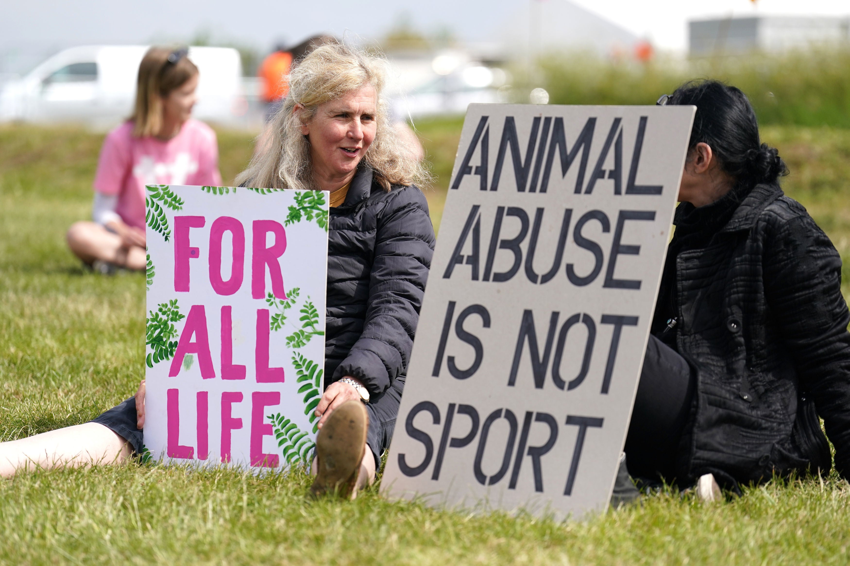 Animal rights protest group Animal Rising with signs outside the entrance to the race course