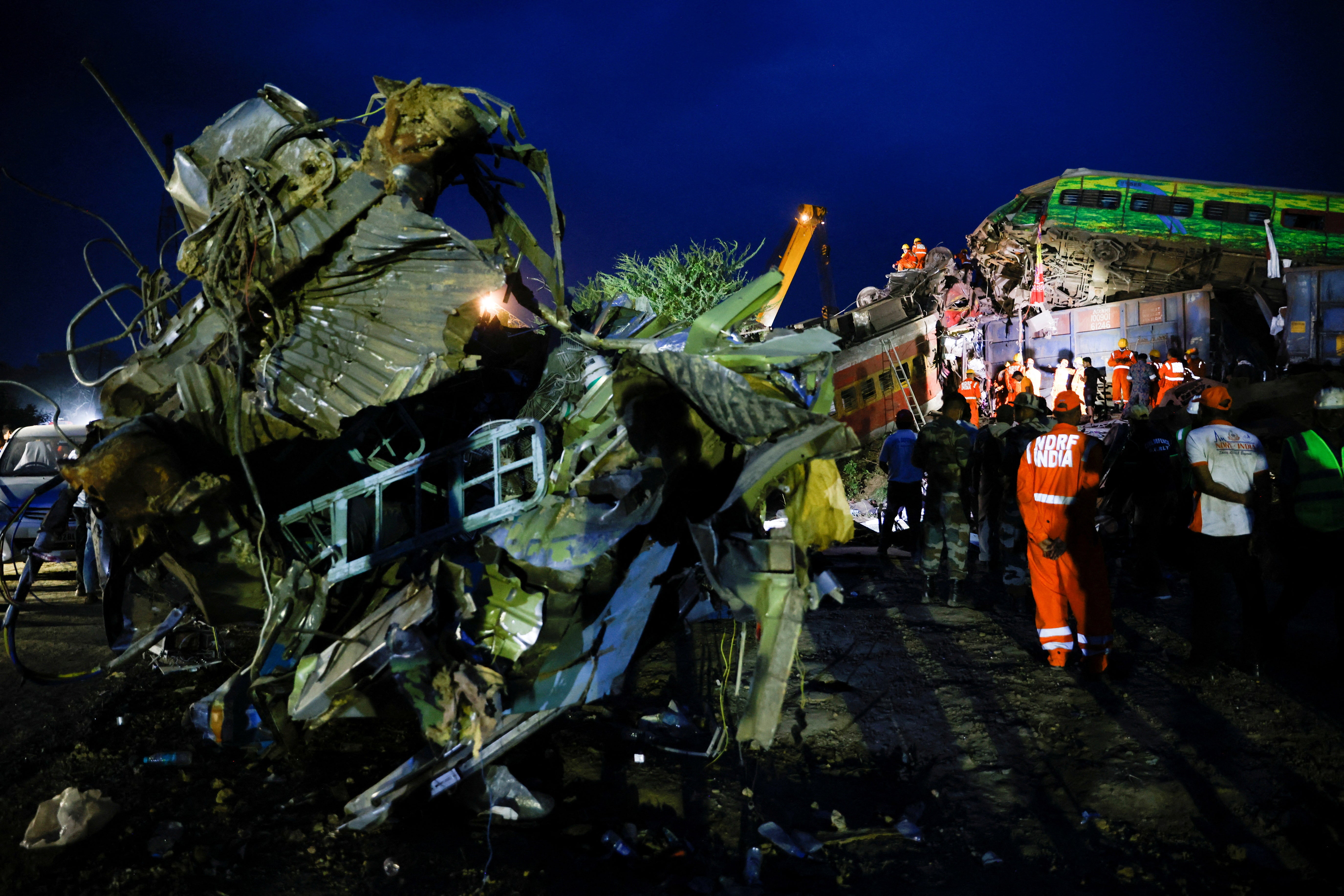 Rescue workers examine the scenes in Odisha