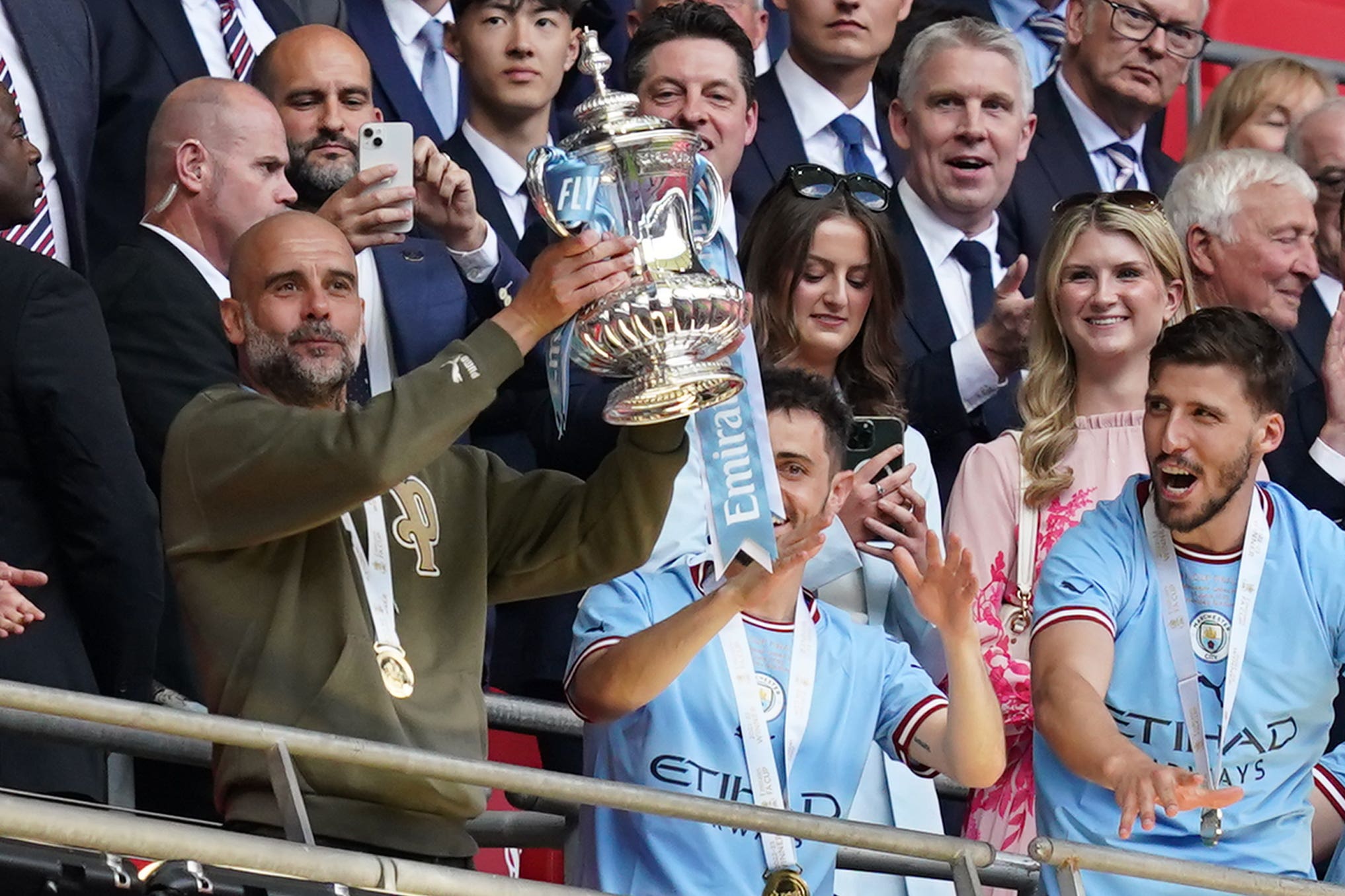 Pep Guardiola (left) has urged Manchester City to cement their greatness by winning the Champions League (Martin Rickett/PA)