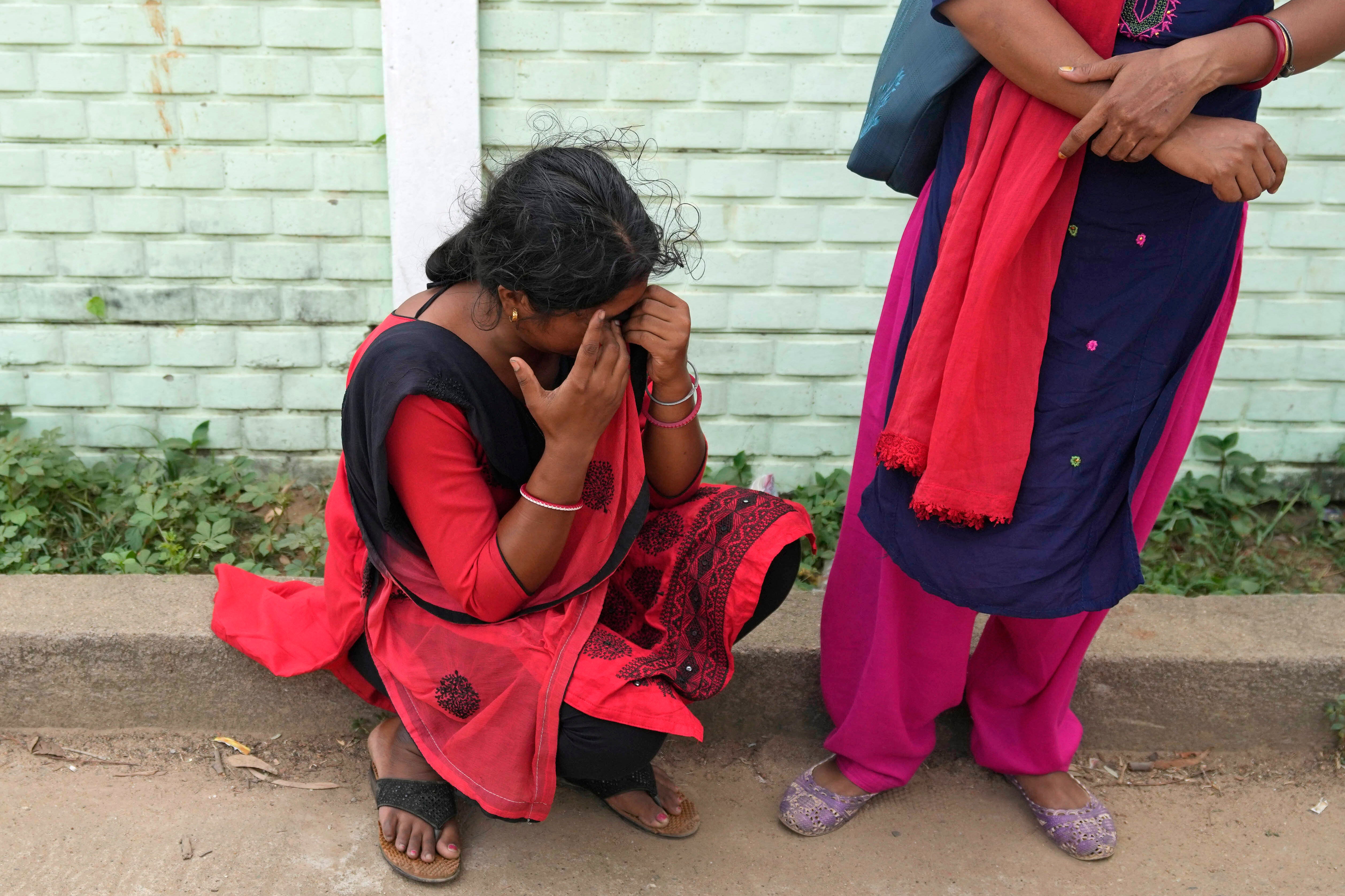 A woman cries while looking for her husband who was traveling in the train that derailed, in Balasore district, in the eastern Indian state of Orissa, 4 June 2023