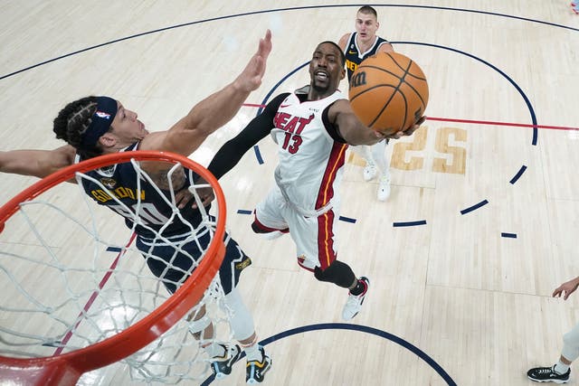 Miami Heat center Bam Adebayo is defended by Denver Nuggets forward Aaron Gordon (Mark J. Terrill/AP)