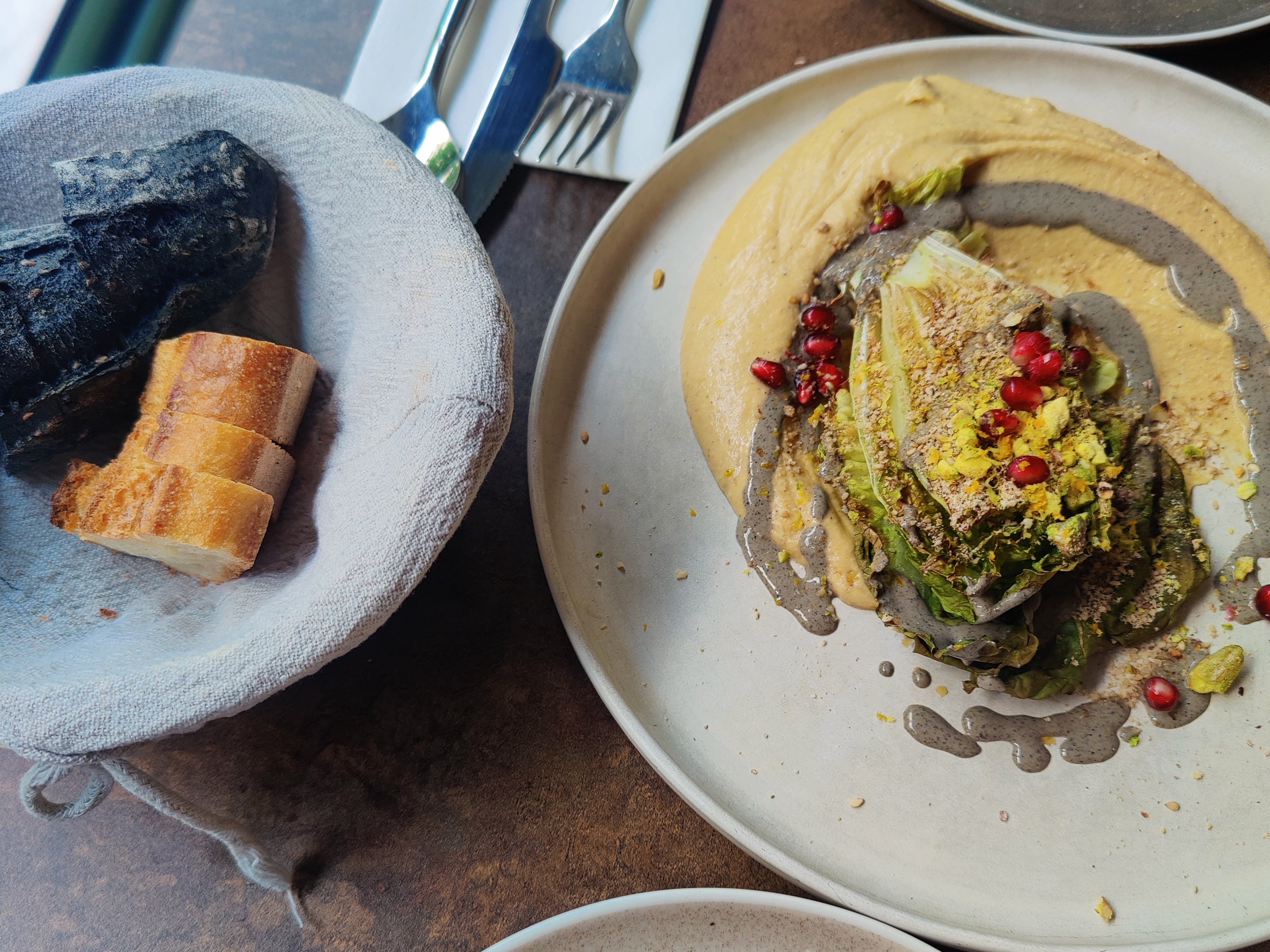 Hummus with black sesame cream, chopped pistachios and pomegranate