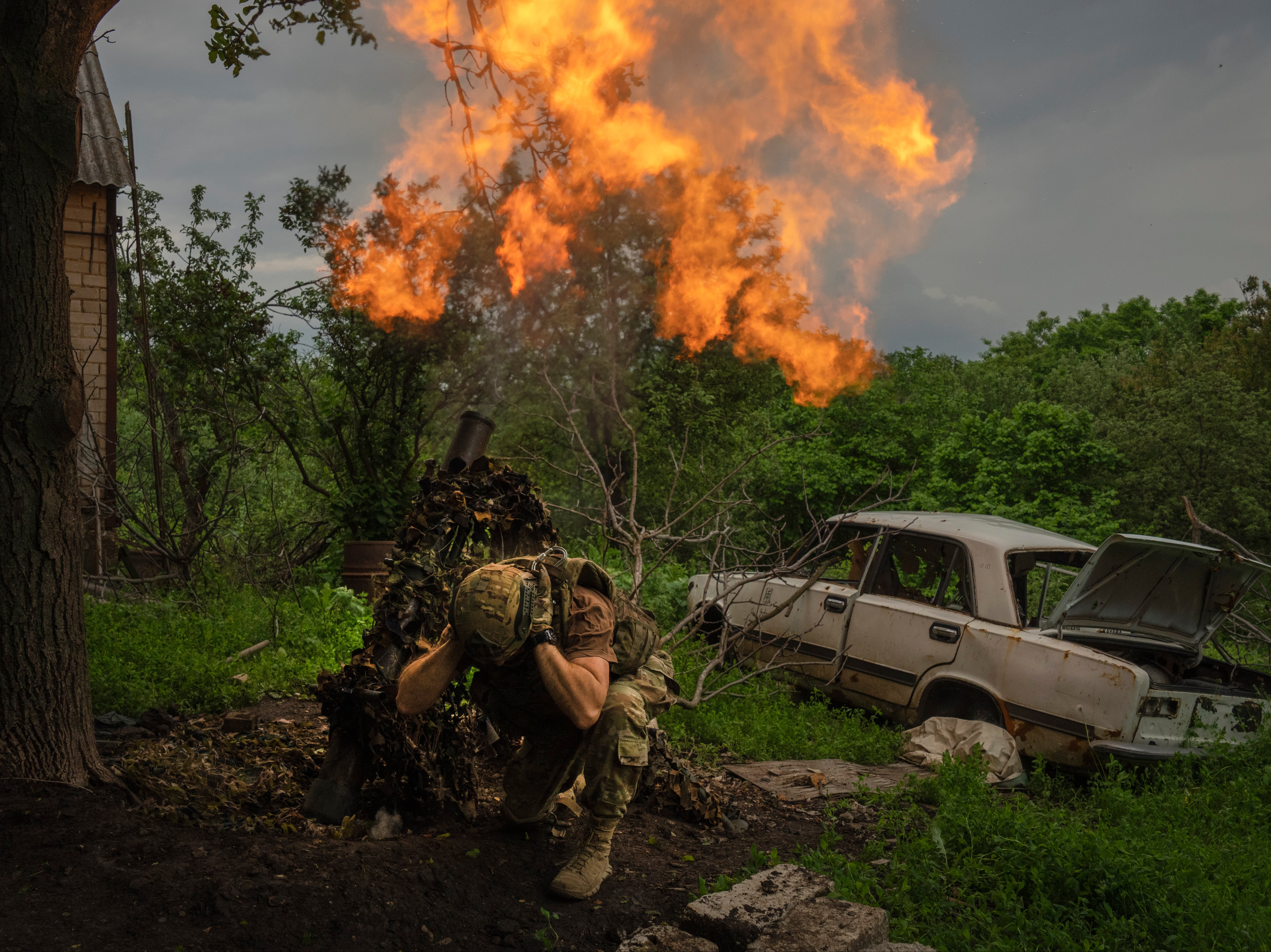 A Ukrainian soldier fires a mortar at Russian positions on the frontline near Bakhmut, Donetsk region