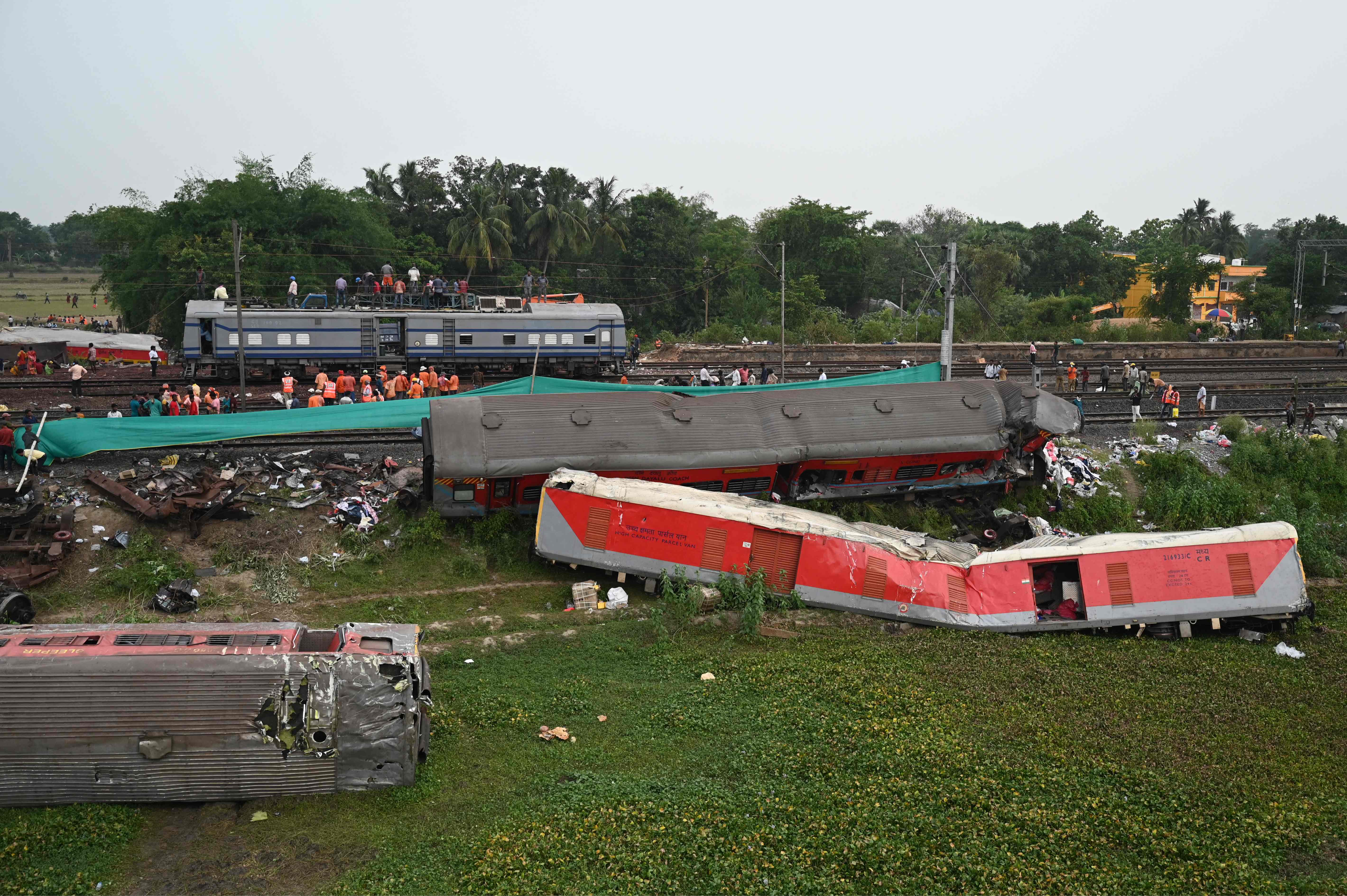 Railway workers help to restore services at the site of the three-train collision near Balasore, about 125 miles from Bhubaneswar in the eastern state of Odisha