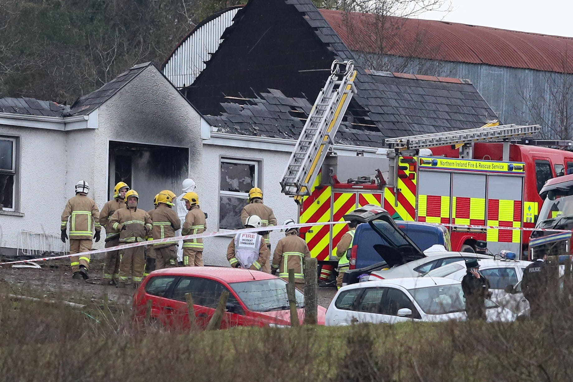 Forensic and fire officers at a house in Derrylin, Fermanagh (Brian Lawless/PA)
