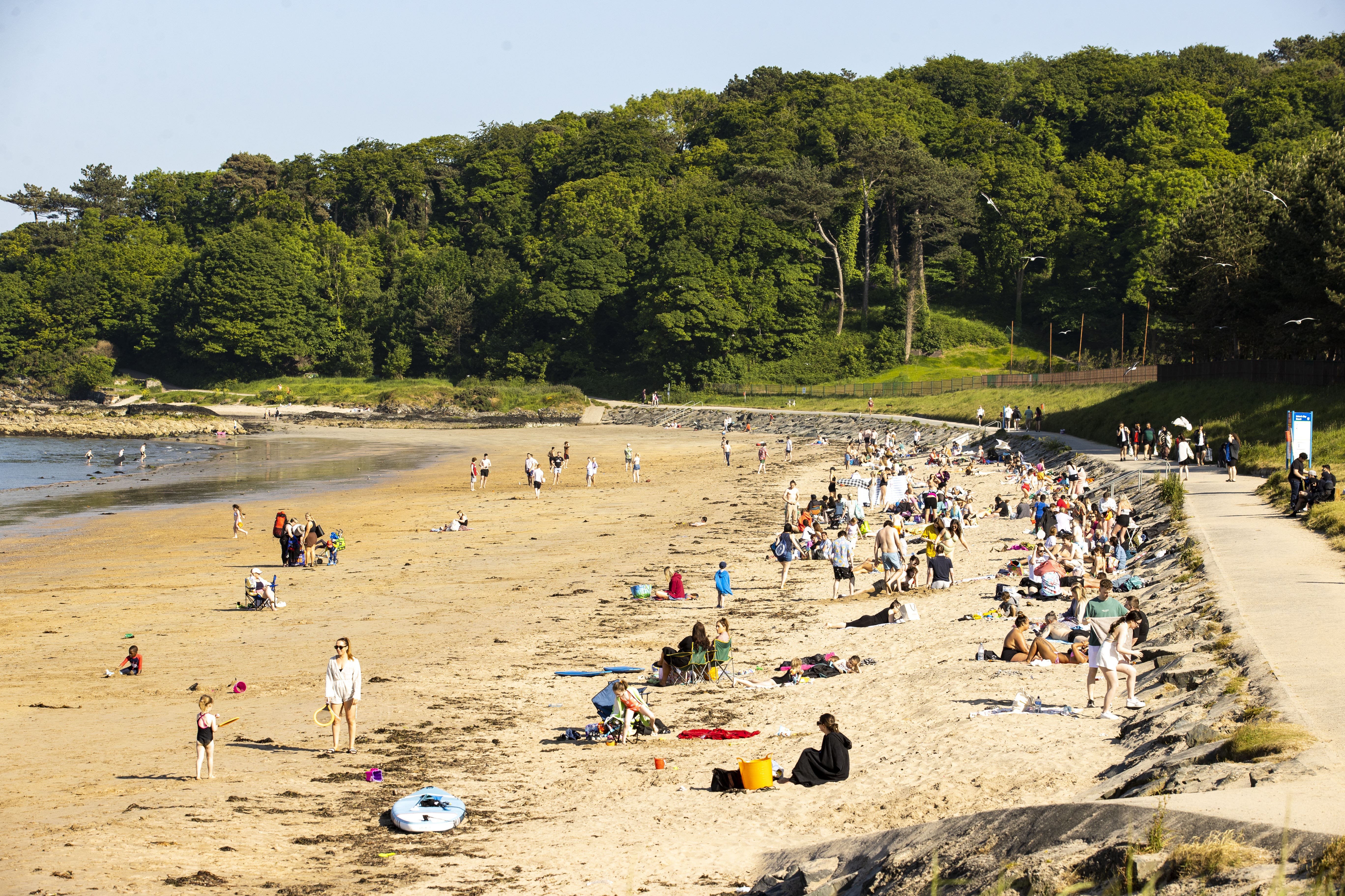 Beachgoers enjoying the warm weather at Helen’s Bay in Bangor, Northern Ireland (Liam McBurney/PA)