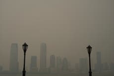 ‘Apocalyptic’ photos capture smoky haze blanketing New York City as moon turns red and air alerts raised