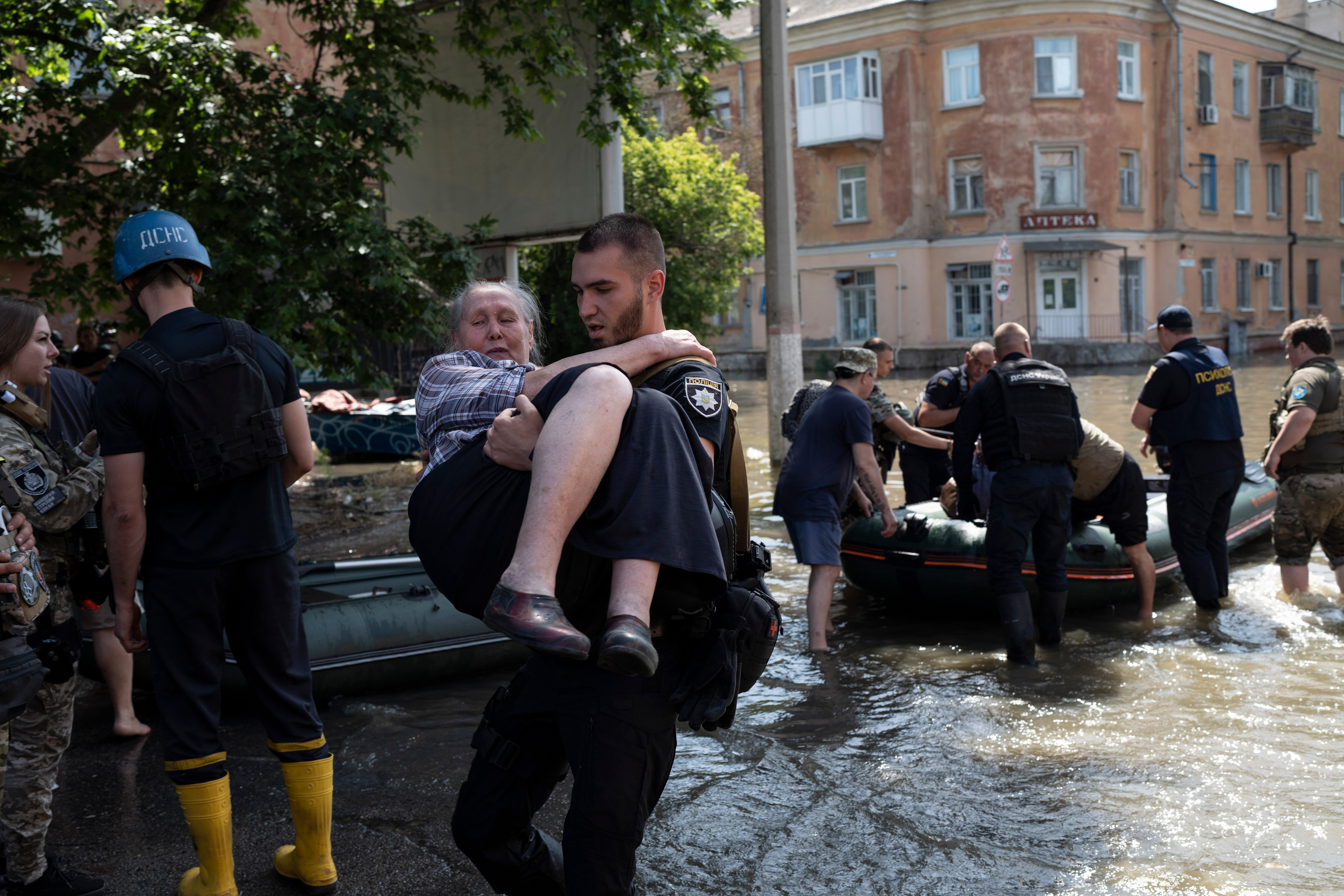 Residents are evacuated from a flooded neighborhood in Kherson,