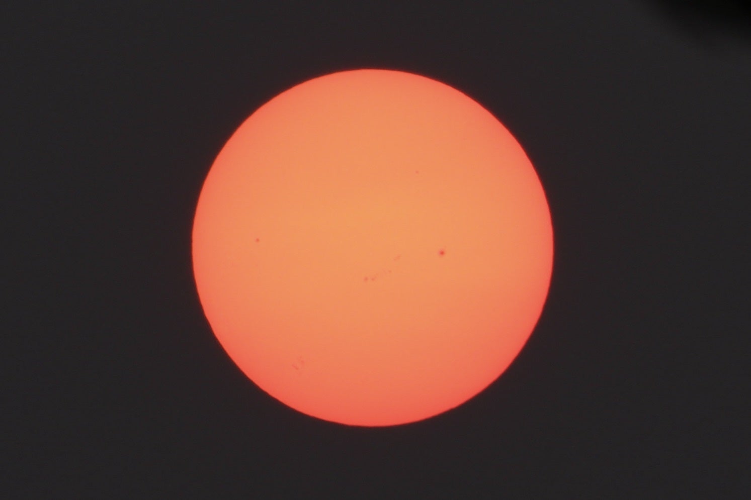 A view of the sun which was turned red due to the fire fumes in the atmosphere