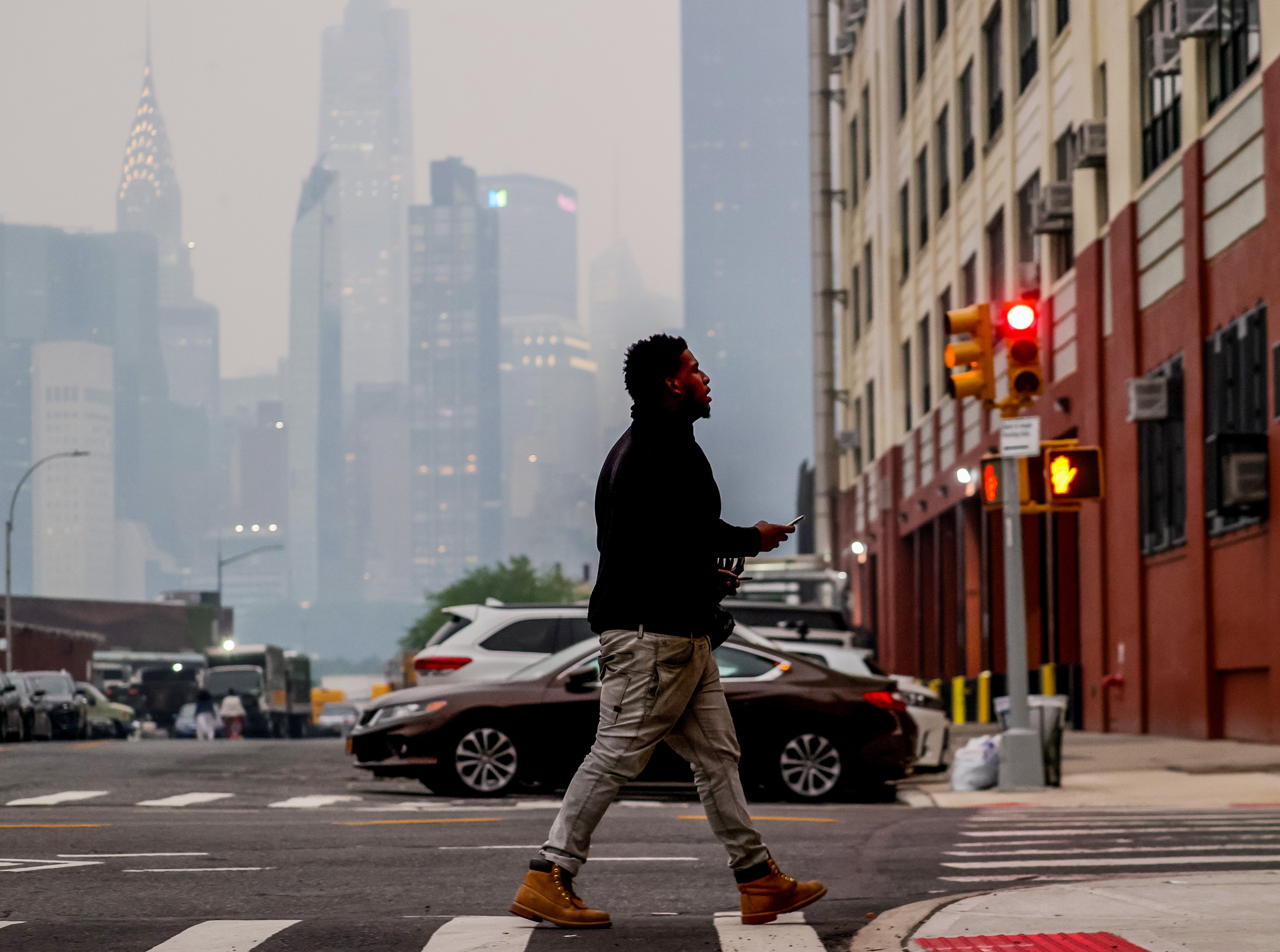 A man walks amid polluted air in New York City, United States