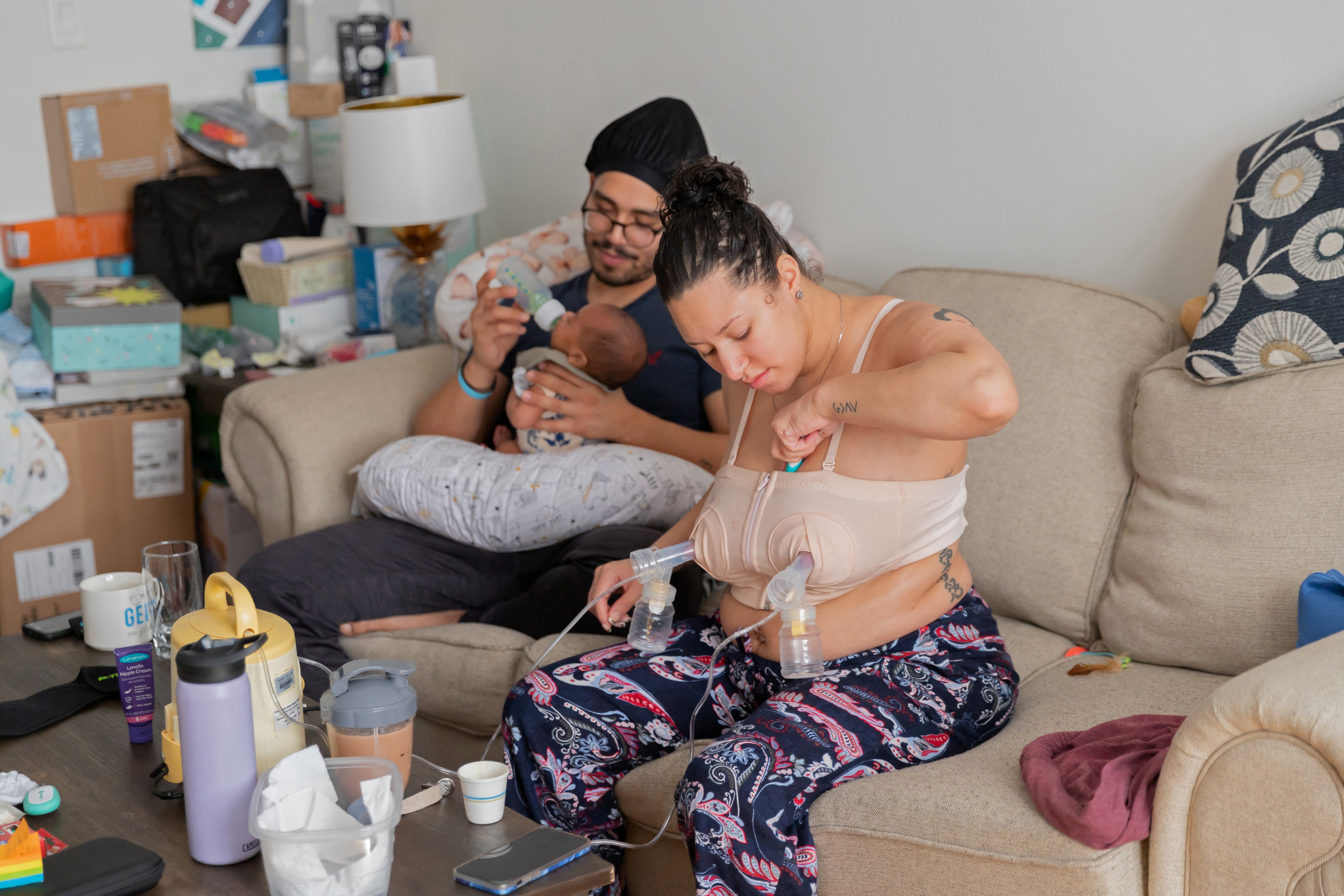 Shariah Bottex pumps milk while her fiance, paramedic Jose Quinonez feeds their son Kaiel