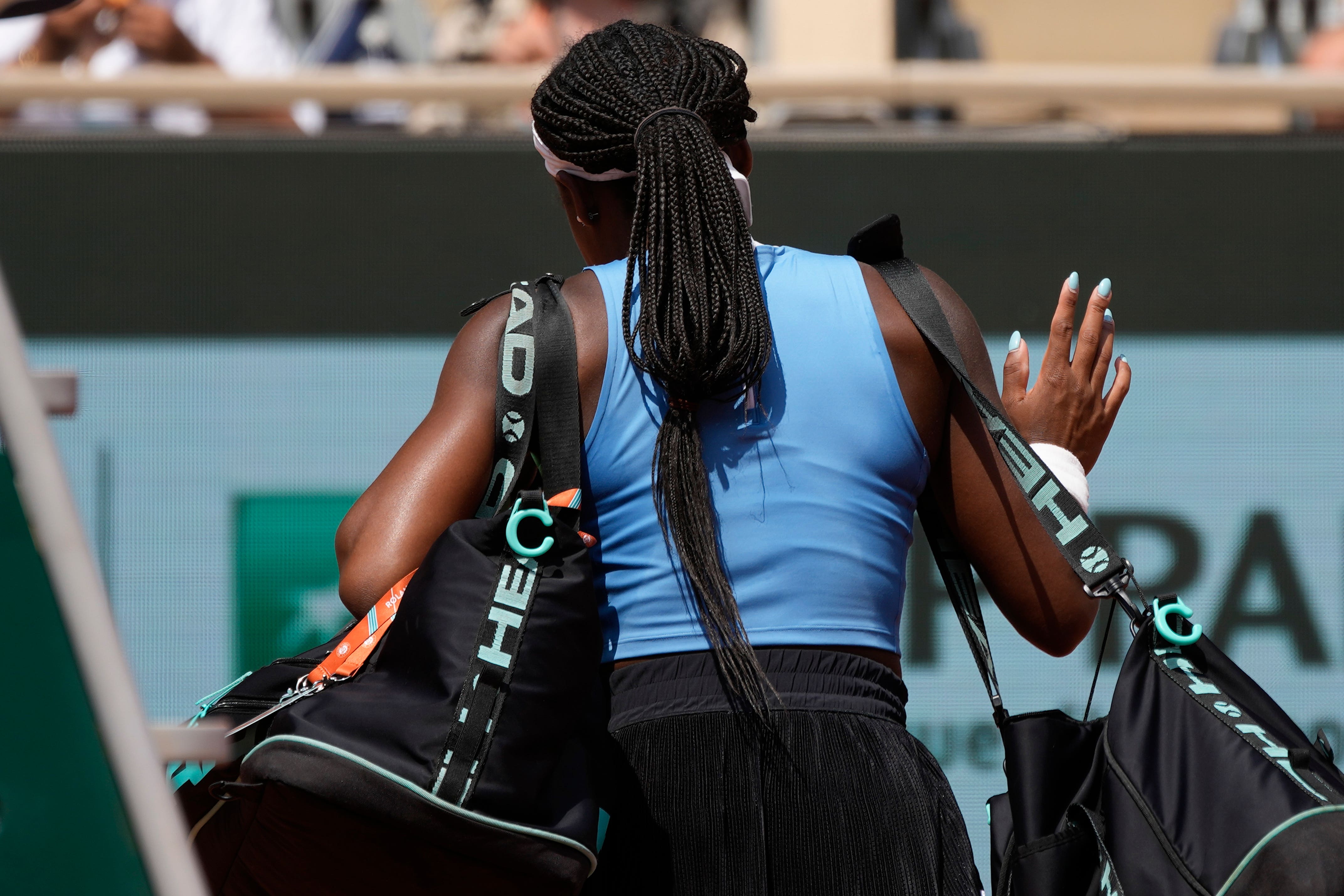 Coco Gauff walks off after losing to Iga Swiatek (Christophe Ena/AP)