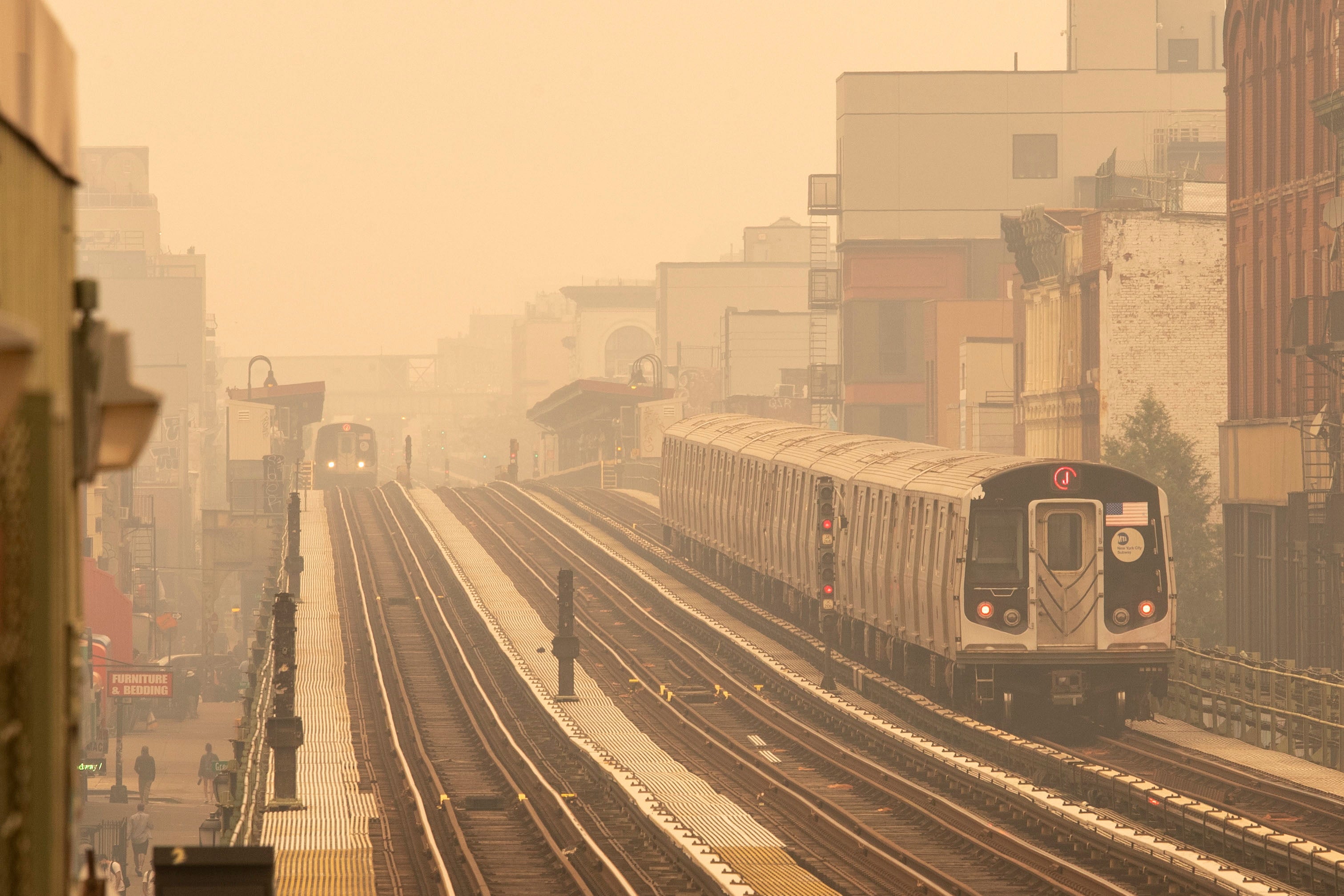 Smoke as a result from Canadian wildfires engulfs the New York area, making it the worst air quality in the world at the moment, as seen on a subway platform in Brooklyn