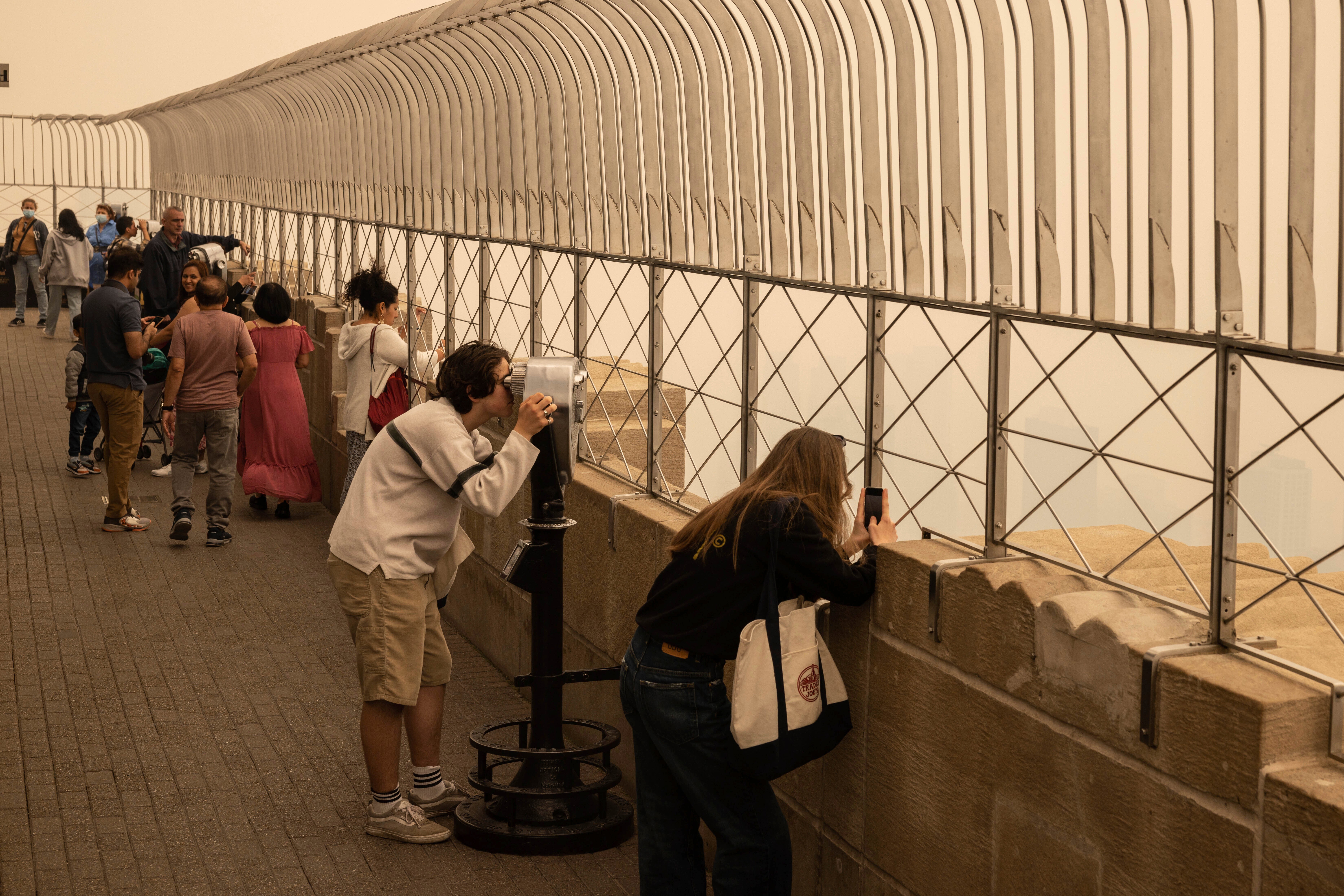 People view New York City in a haze-filled sky from the Empire State Building observatory, on Wednesday