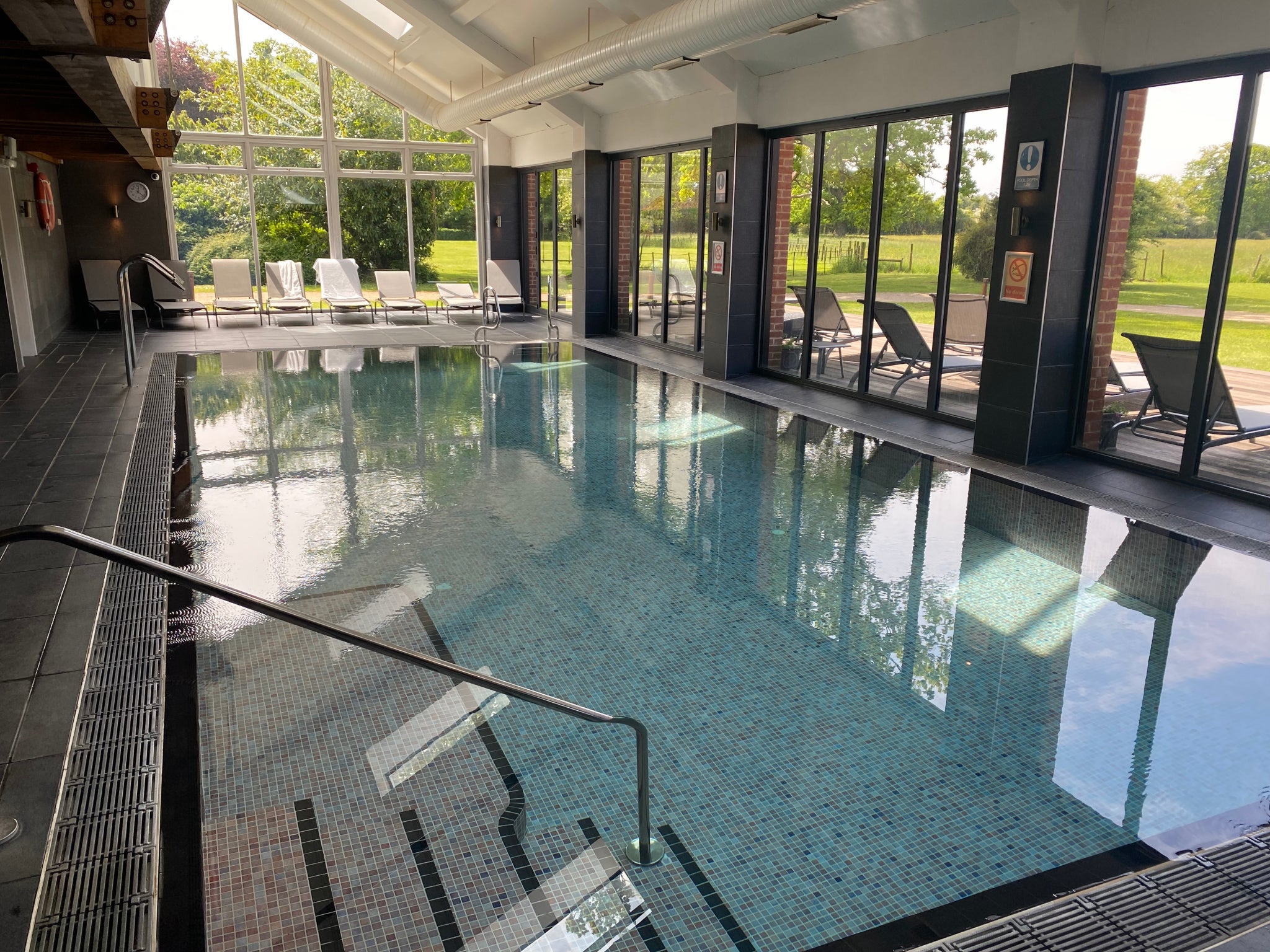 Floor-to-ceiling windows surround the indoor pool