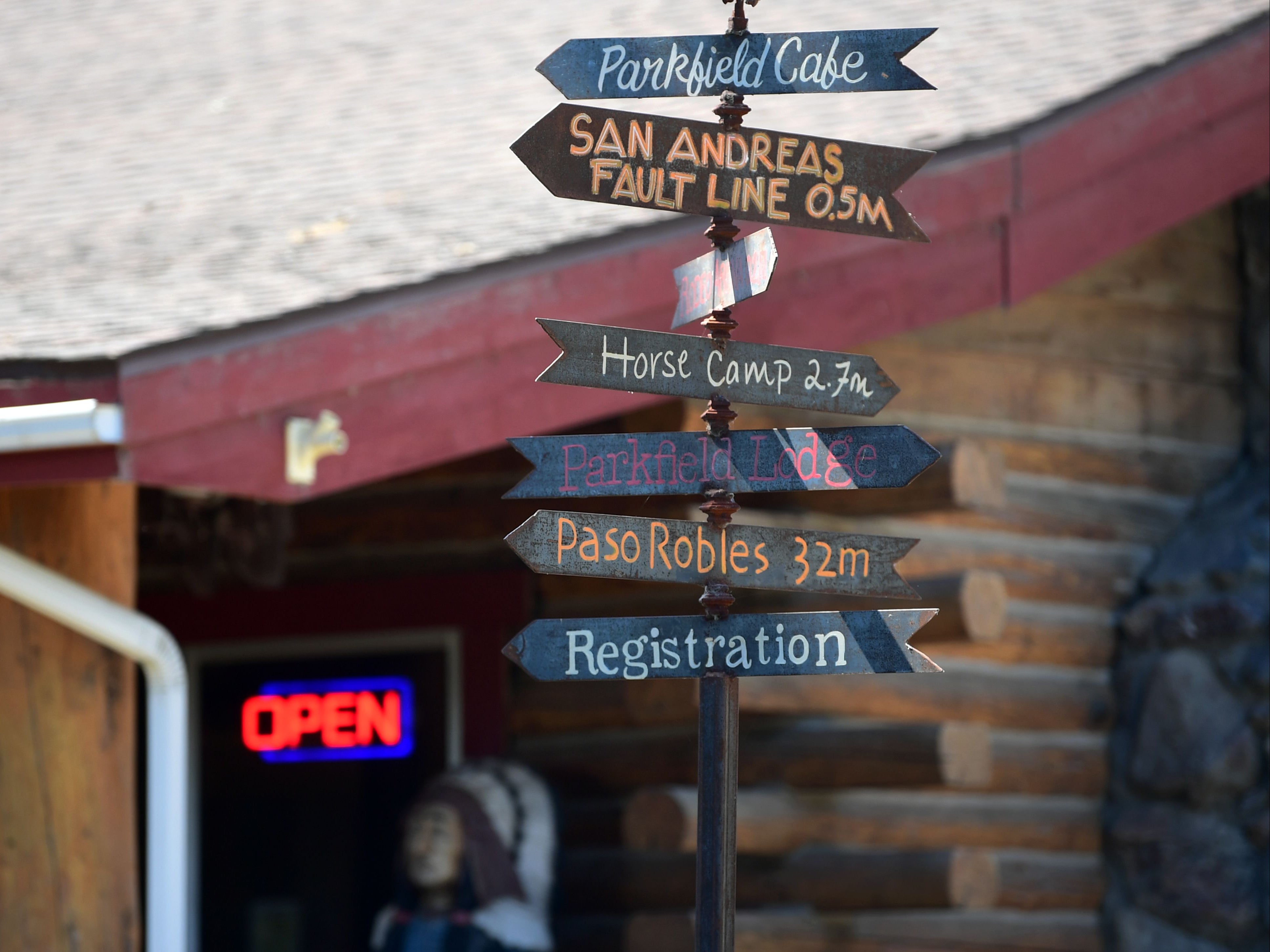 A signpost in front of the Parkfield Cafe offers information and directions to various places, including the nearby San Andreas Fault which runs under the small population town of Parkfield on July 12, 2019