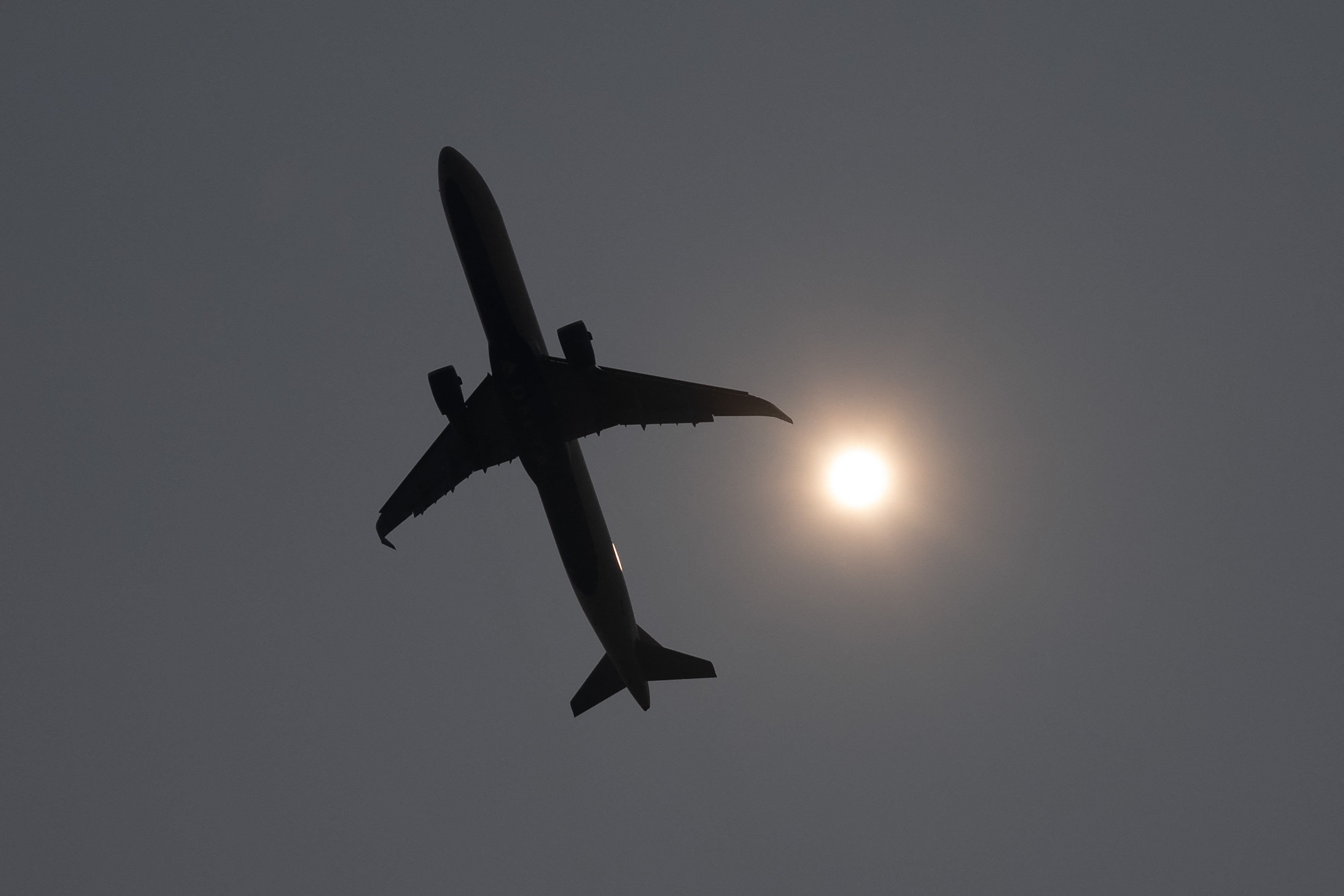 A Delta plane takes off into a smoke haze from Washington National Airport in Arlington, Virginia