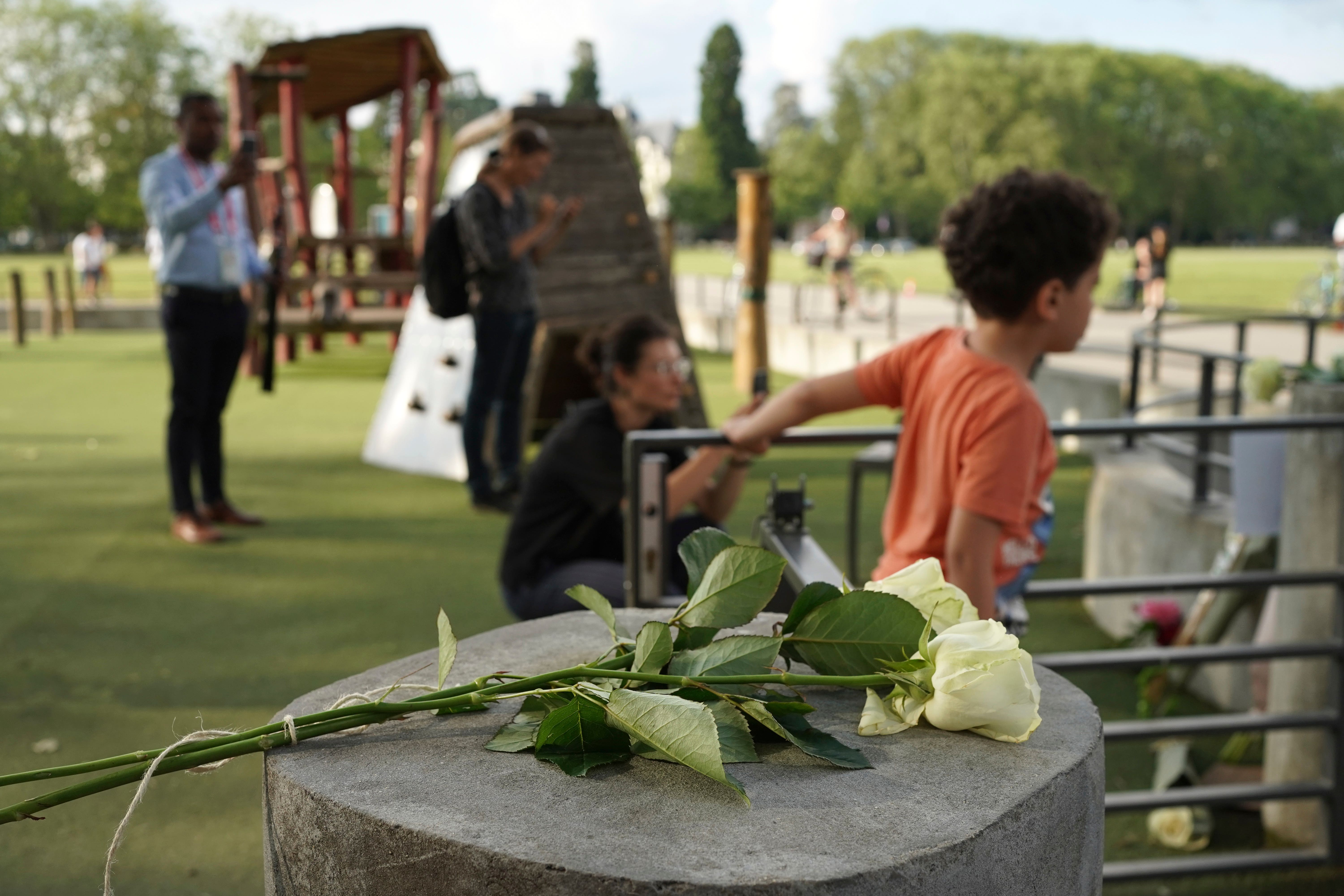 Roses lay at the playground after a knife attack in Annecy, French Alps (Laurent Cipriani/AP)