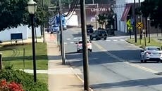 Moment train ploughs through lorry stuck on tracks in North Carolina