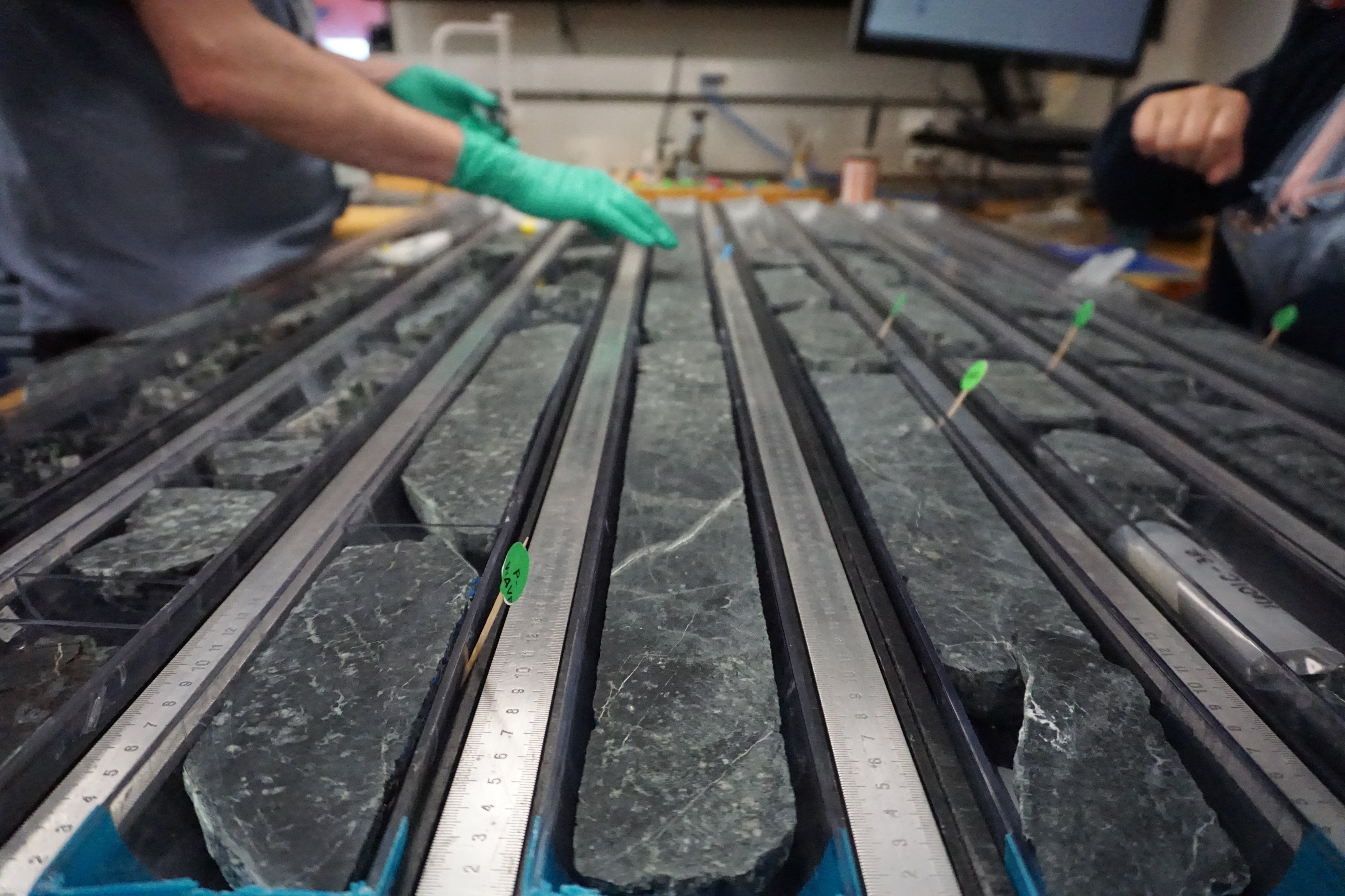 Researchers aboard the Joides Resolution saw the rock cores in half, creating a resource for future study