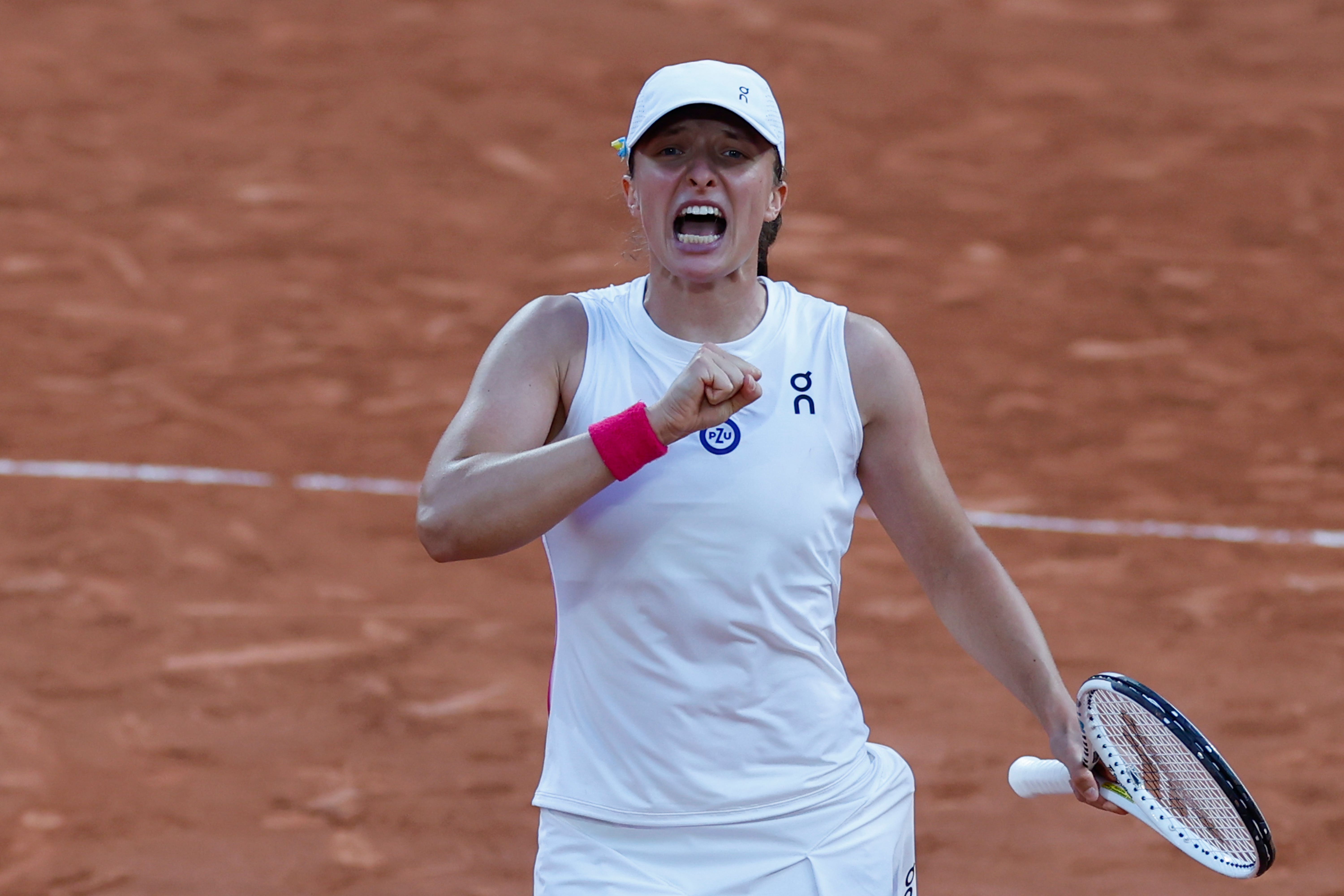 Iga Swiatek celebrates winning her semi-final match (Jean-Francois Badias/AP)