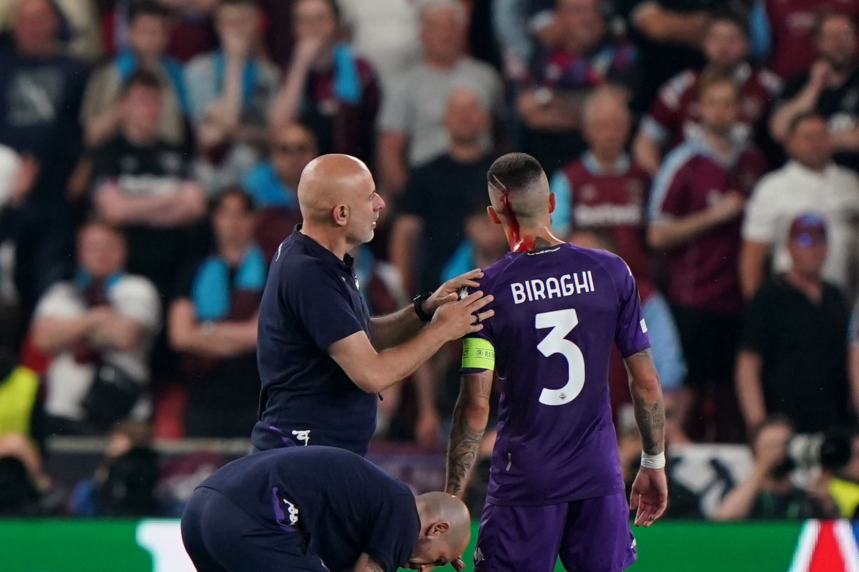 Fiorentina’s Cristiano Biraghi recieves treatment for a head injury after being struck by a plastic cup thrown from the crowd during the UEFA Europa Conference League Final at the Fortuna Arena, Prague. Picture date: Wednesday June 7, 2023.