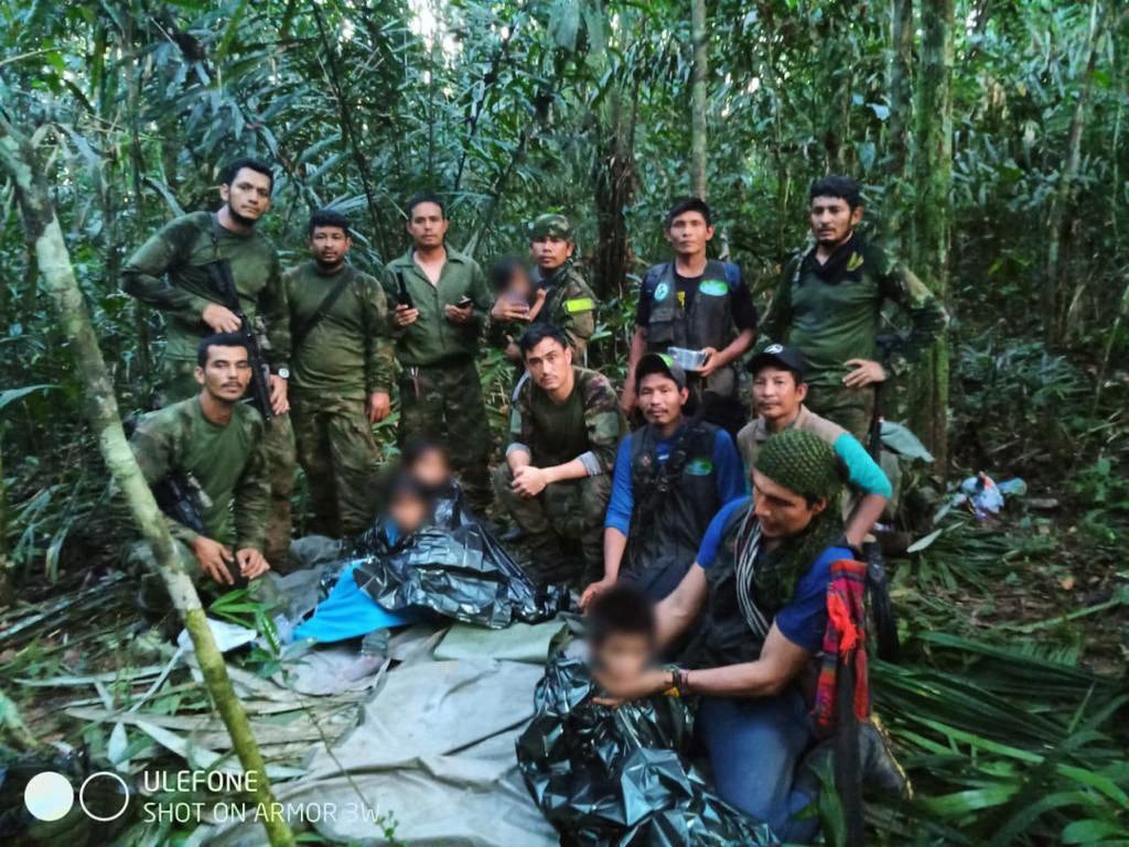 Members the Army pose with four Indigenous children after spending more than a month lost in the Colombian Amazon rainforest