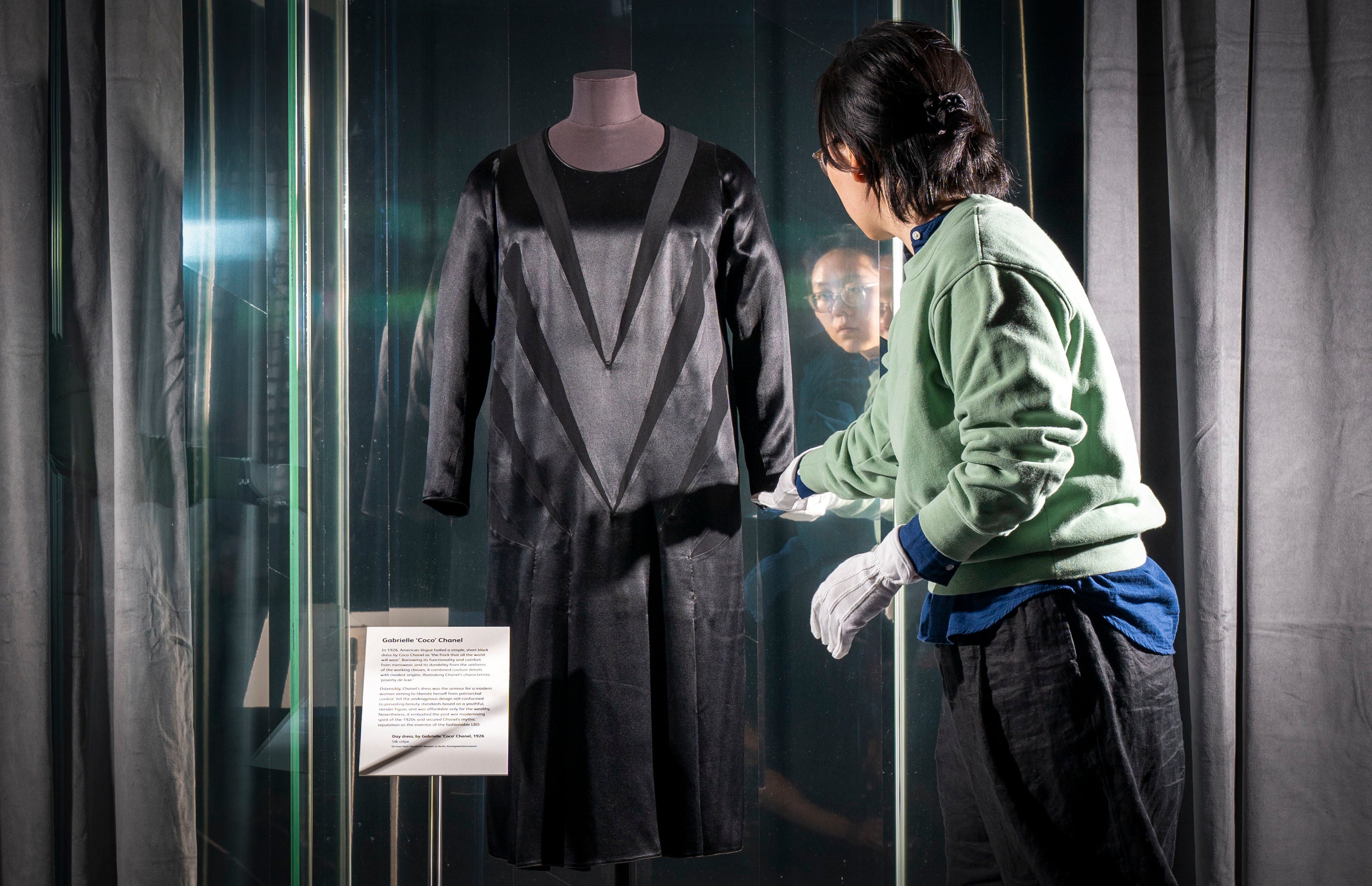 Textile Conservator Yufei Xiang at the National Museum of Scotland in Edinburgh, makes final adjustments to Coco Chanel's original 'Little Black Dress' (1926)