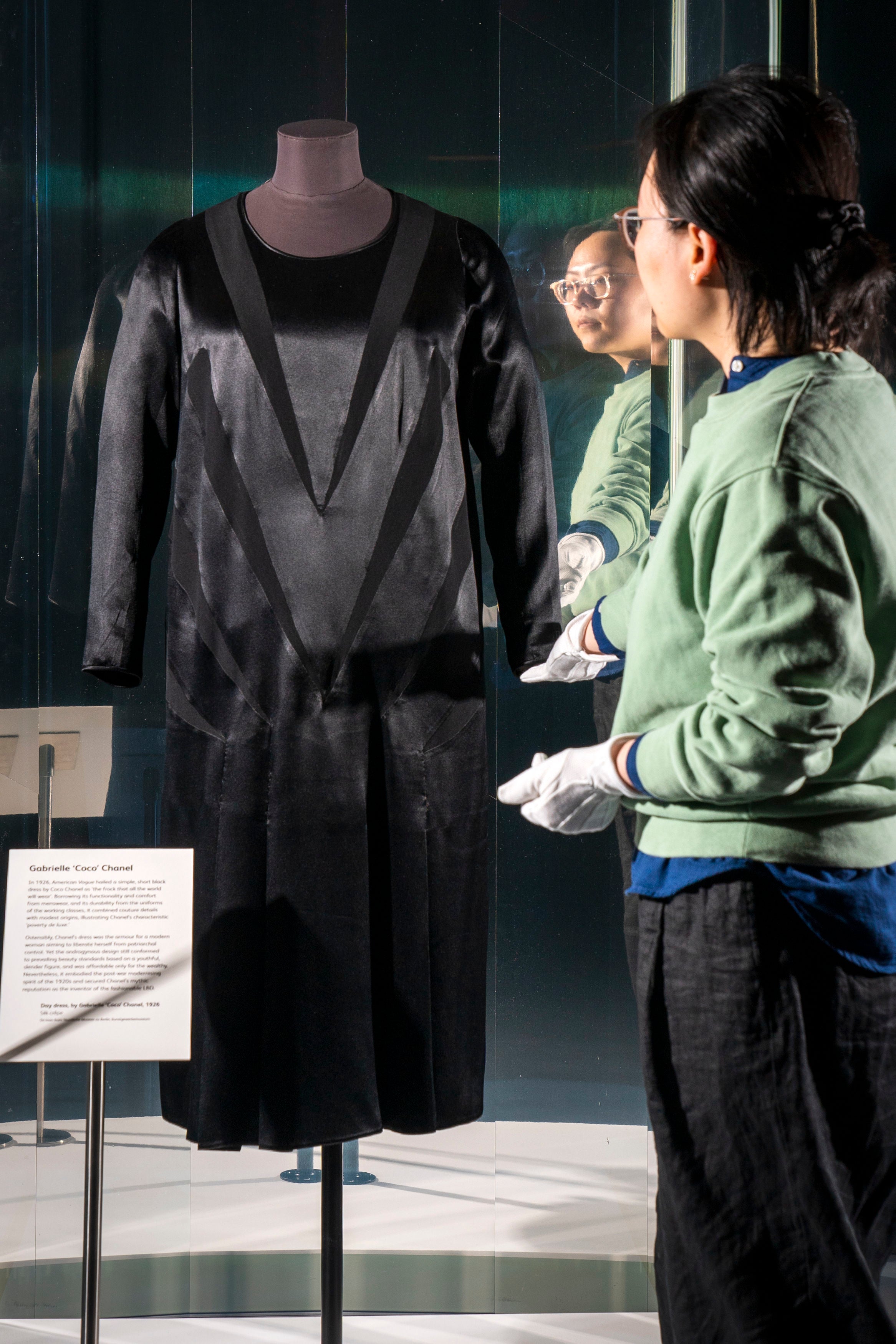 Textile Conservator Yufei Xiang at the National Museum of Scotland in Edinburgh, makes final adjustments to Coco Chanel's original 'Little Black Dress' (1926) prior to it going on show in the Beyond The Little Black Dress exhibition on 1 July