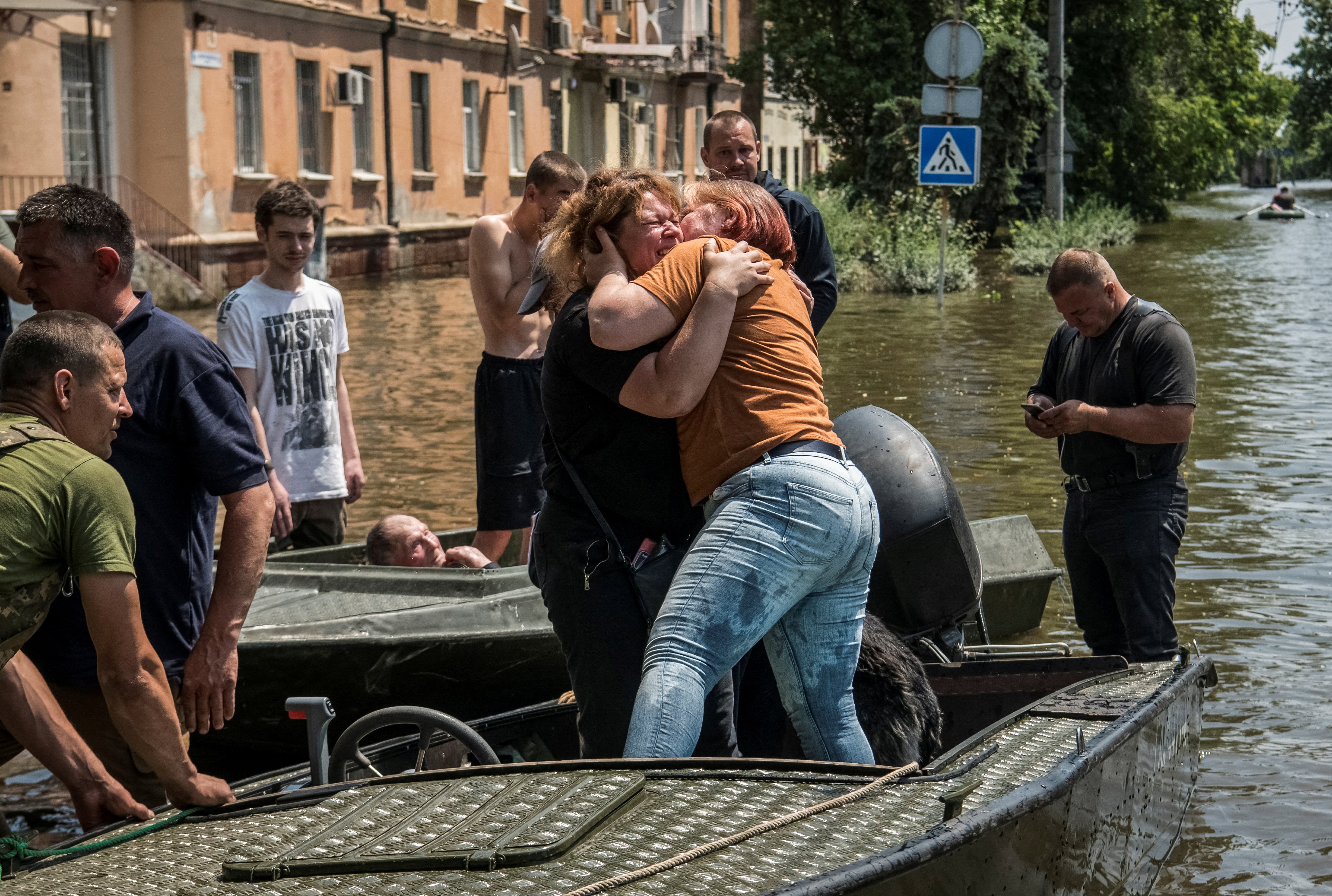 Local residents react during an evacuation from a flooded area of Kherson, after the Nova Kakhovka dam was partially destroyed