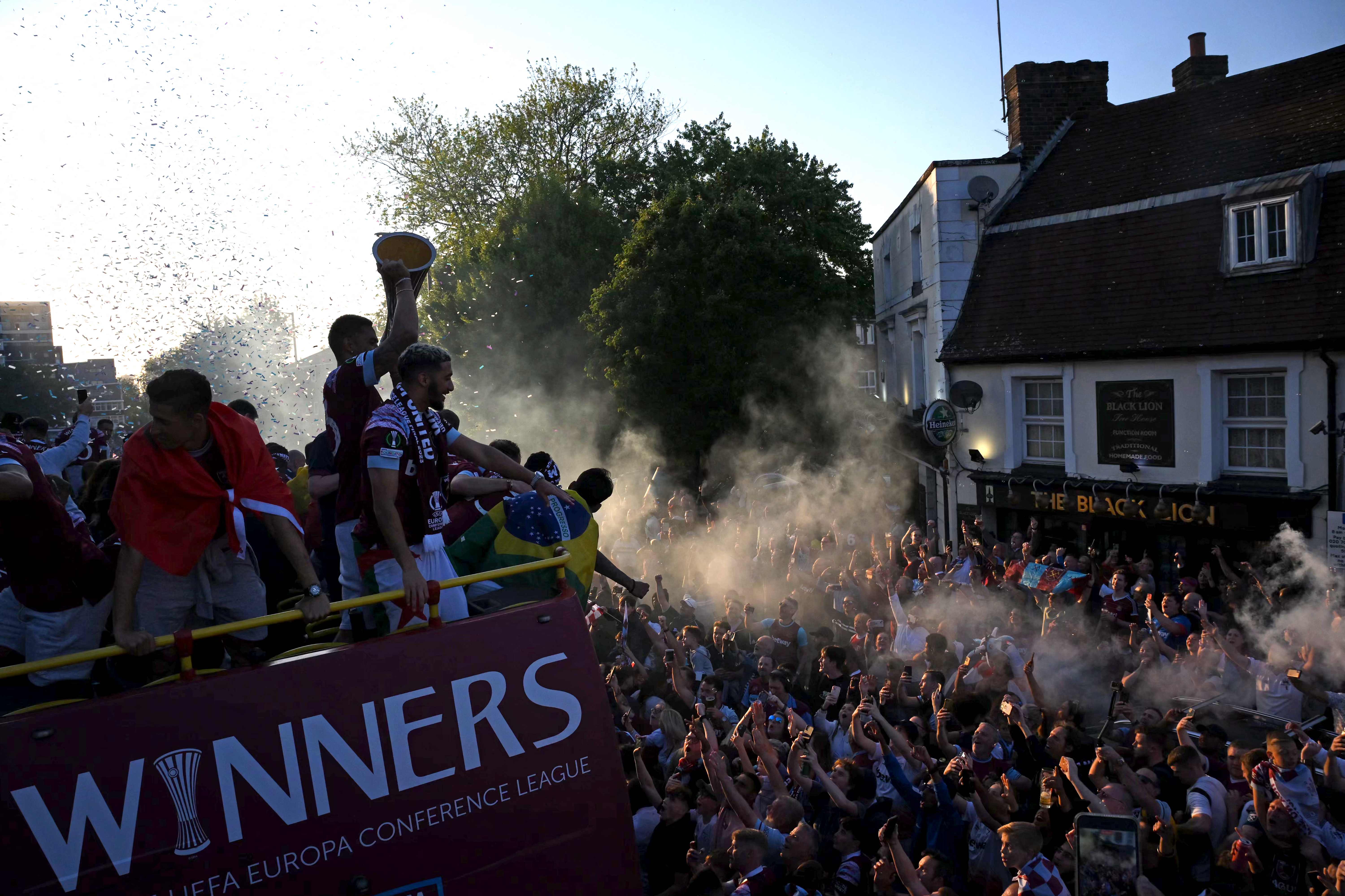 Fans line the route as West Ham players travel on an open-top bus trophy parade, through the streets of east London to celebrate winning the Europa Conference League final