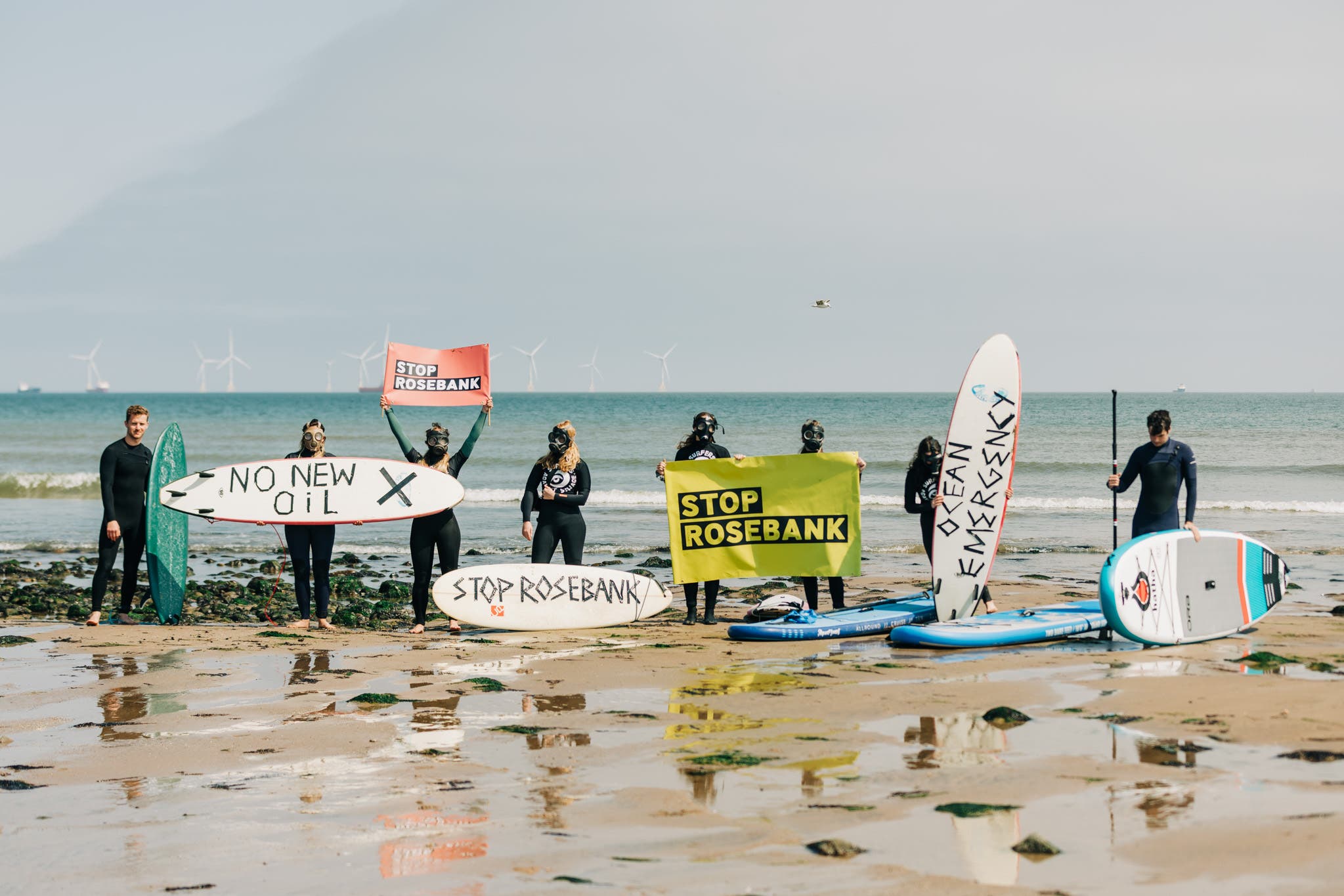 Activists on the beach in Aberdeen have called for an end to the planned development of the Rosebank oil and gas field (Andrew Perry/PA)