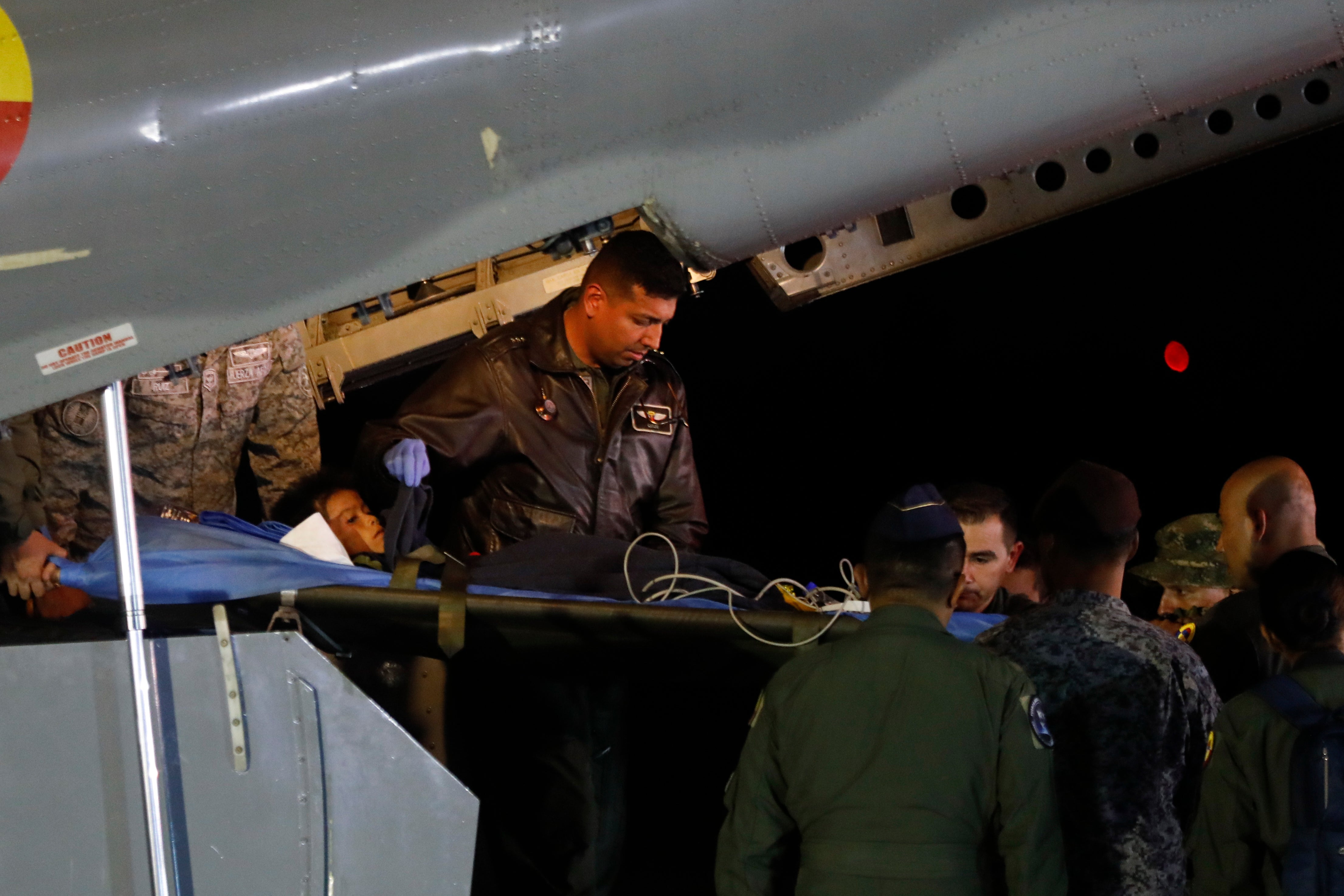 Military personnel unload from a plane one of four Indigenous children who were missing after a deadly plane crash at the military air base in Bogota, Colombia, Saturday, 10 June 2023. The children survived a small plane crash 40 days ago and had been the subject of an intense search in the jungle.