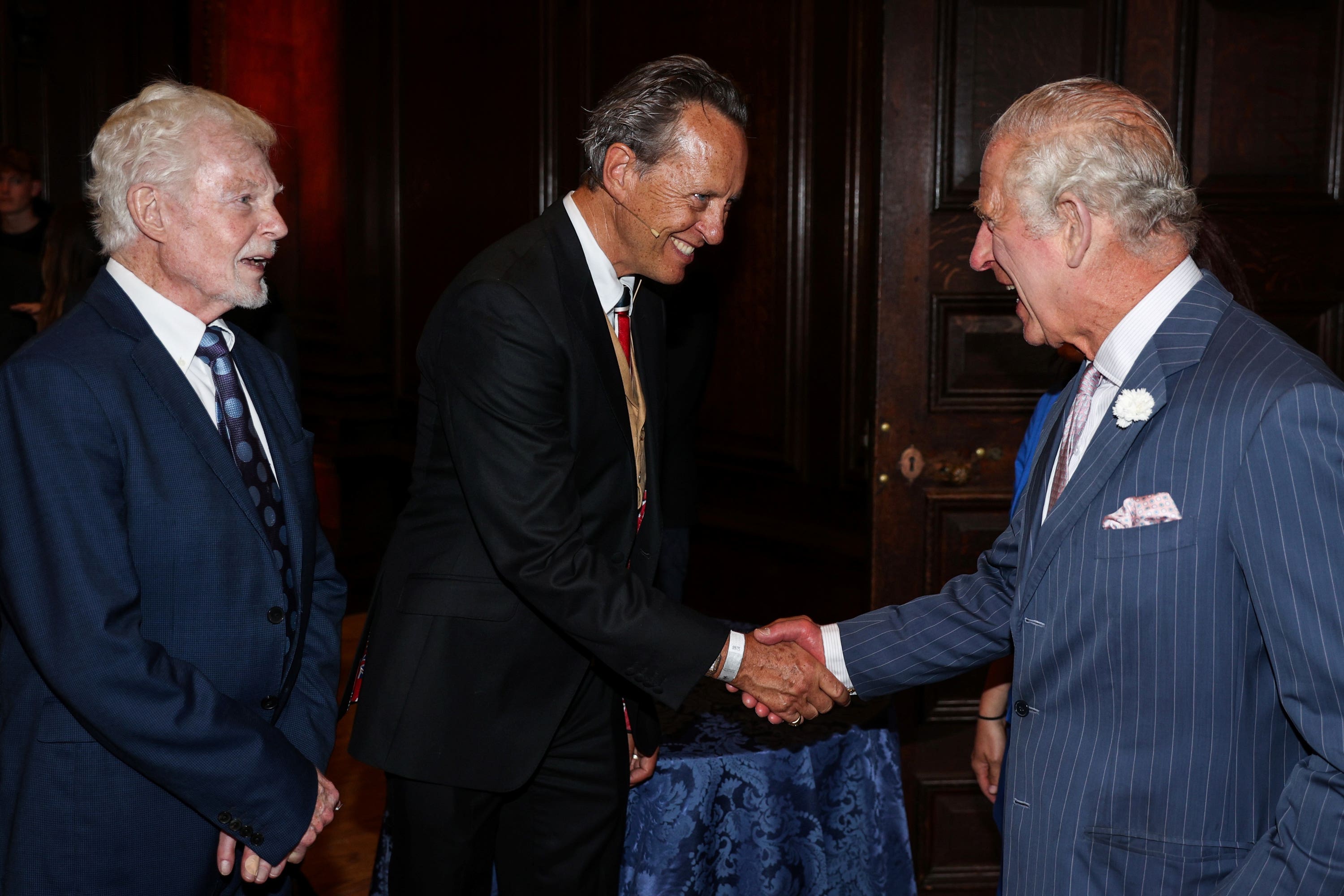 Charles greets Derek Jacobi and Richard E Grant during a reception (Adrian Dennis/PA)