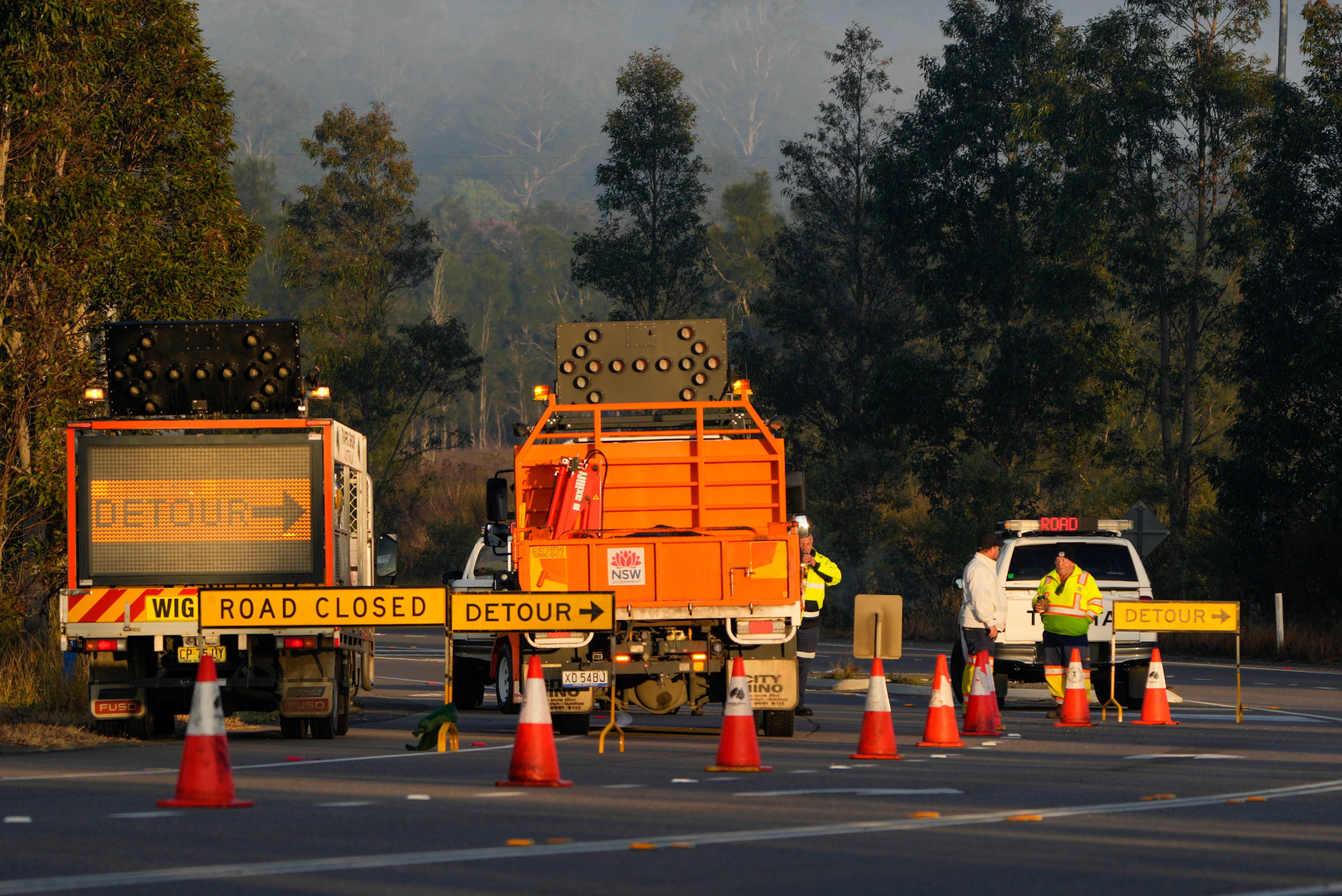 Emergency workers man a roadblock near the town of Greta following a bus crash in the Hunter Valley, north of Sydney, Australia