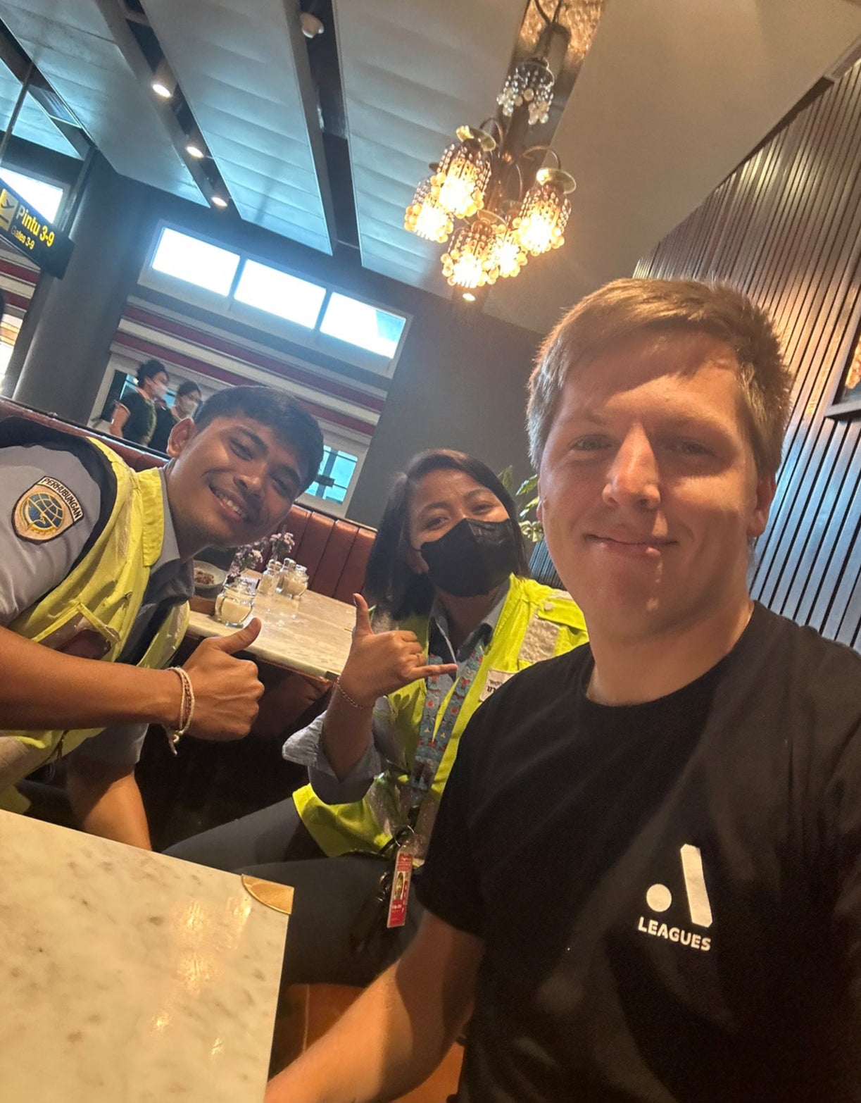 Mr Vandenberg with his two chaperones at Denpasar airport