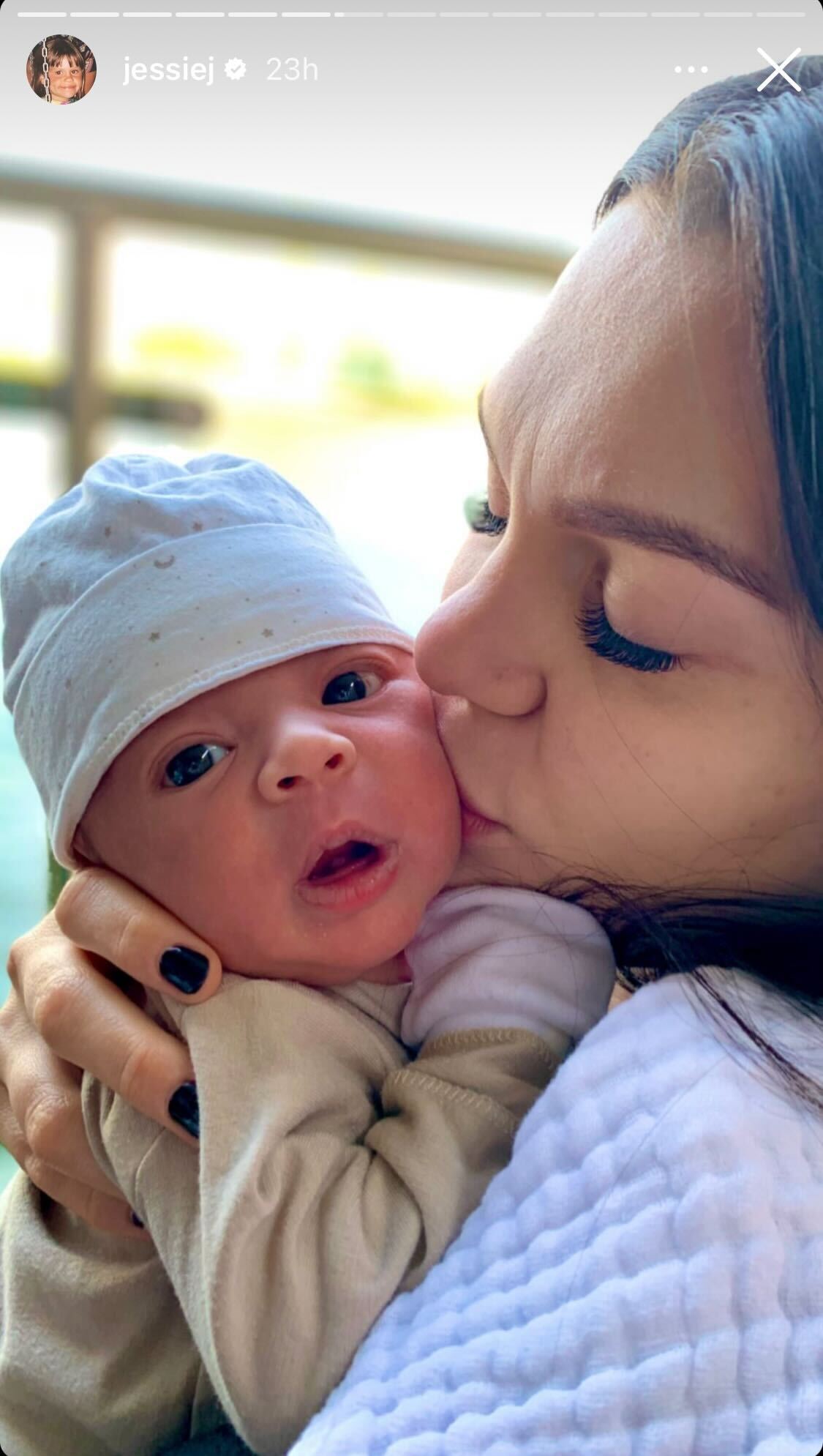 Jessie J plants a kiss on her newborn son Sky’s cheek