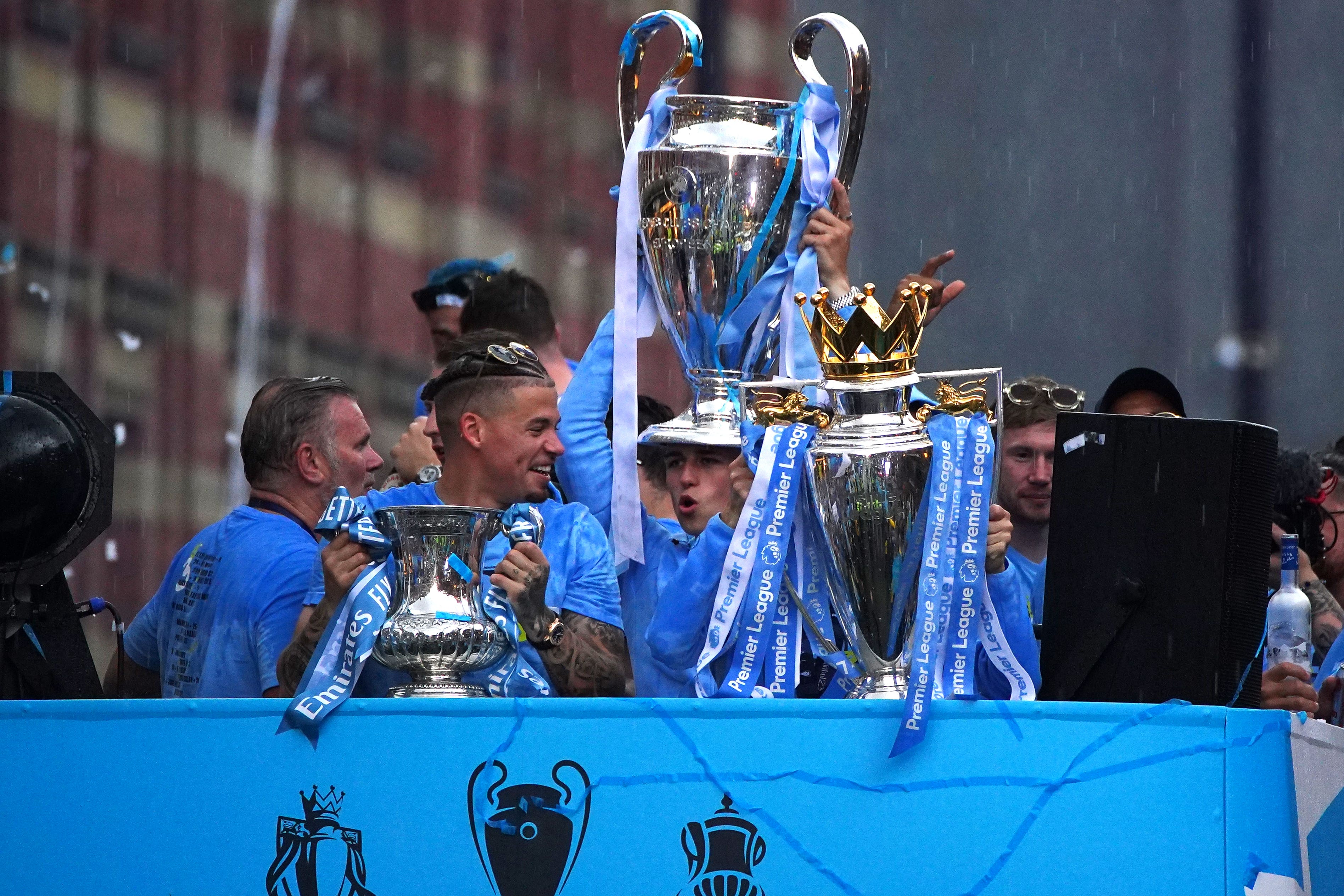 Kalvin Phillips celebrates Man City’s treble during a parade