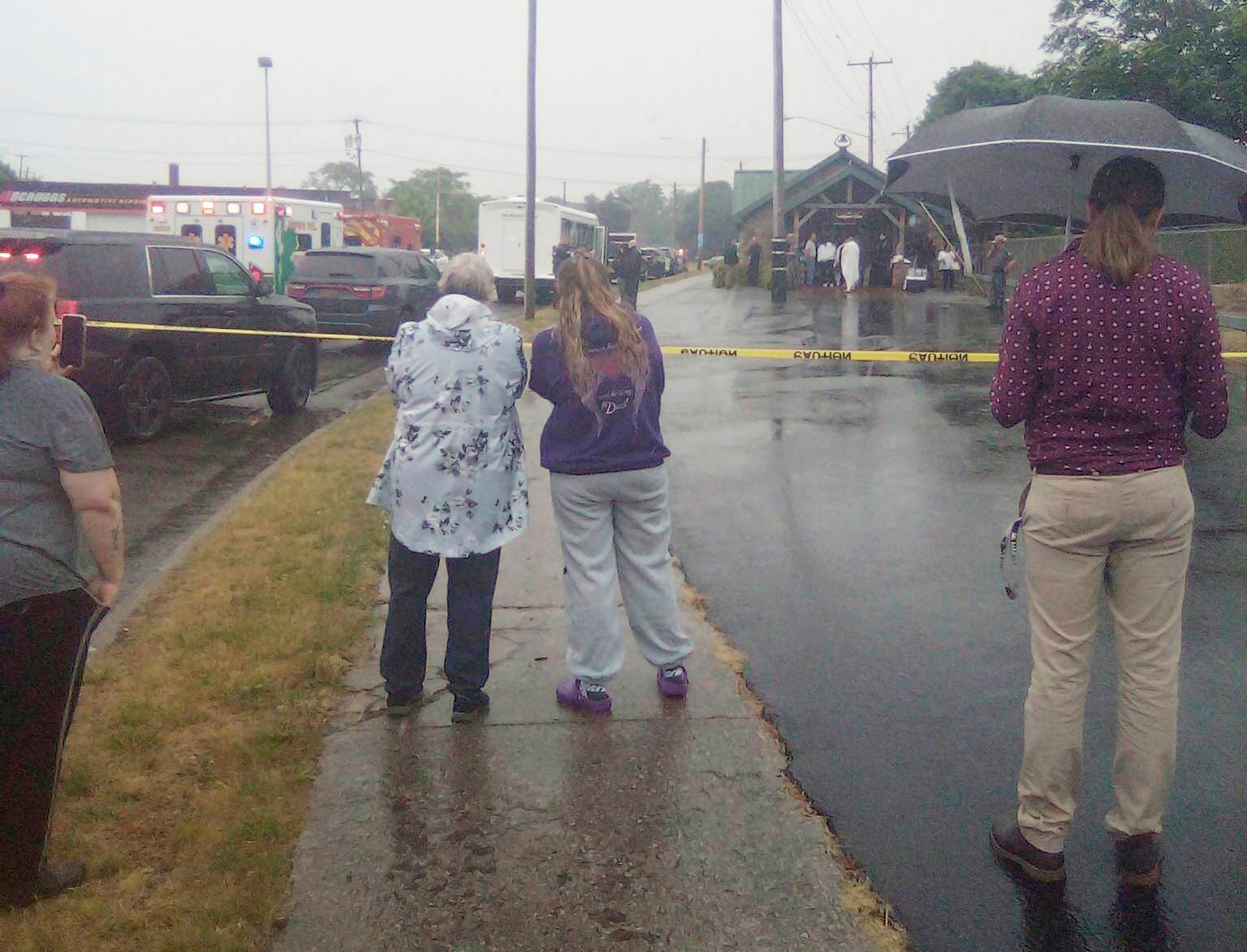 This photo provided by Thomas Coleman shows people watching as people are rescued after a boat capsized Monday,