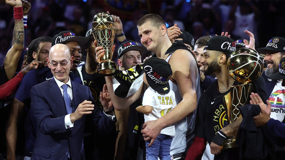 Nikola Jokic celebrates winning the NBA championship and Finals MVP with the Denver Nuggets