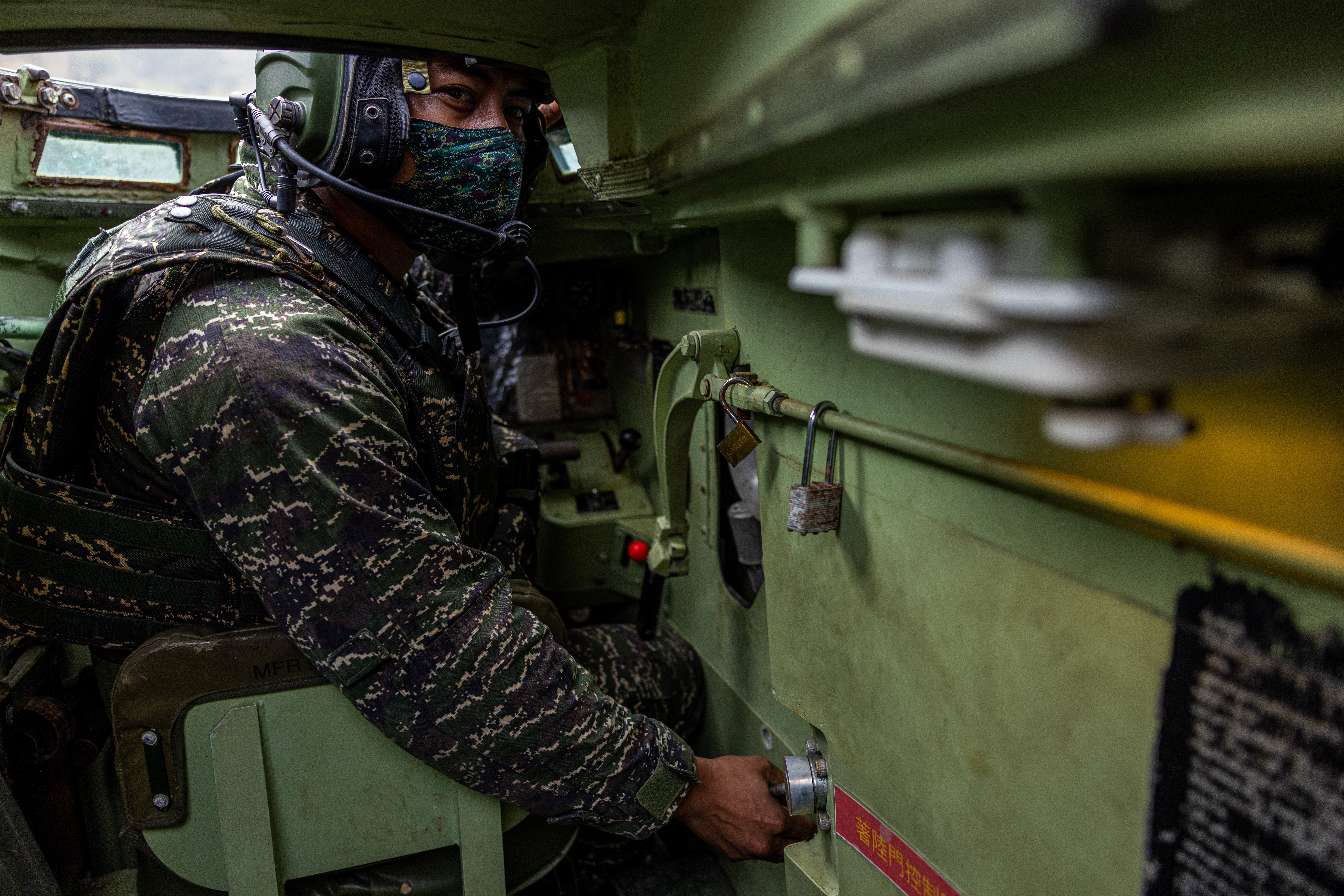 A Taiwanese soldier manoeuvres an AAVP7 amphibious vehicle during the two-day routine drills at a military base in Kaohsiung in Taiwan