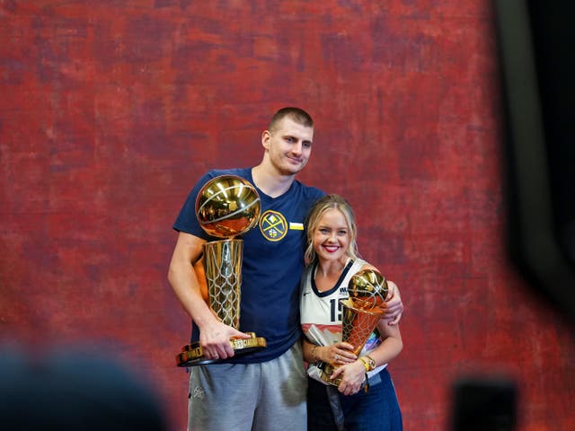 <p>Denver Nuggets centre Nikola Jokic and his wife Natalija with the Larry O’Brien NBA Championship Trophy and MVP award</p>