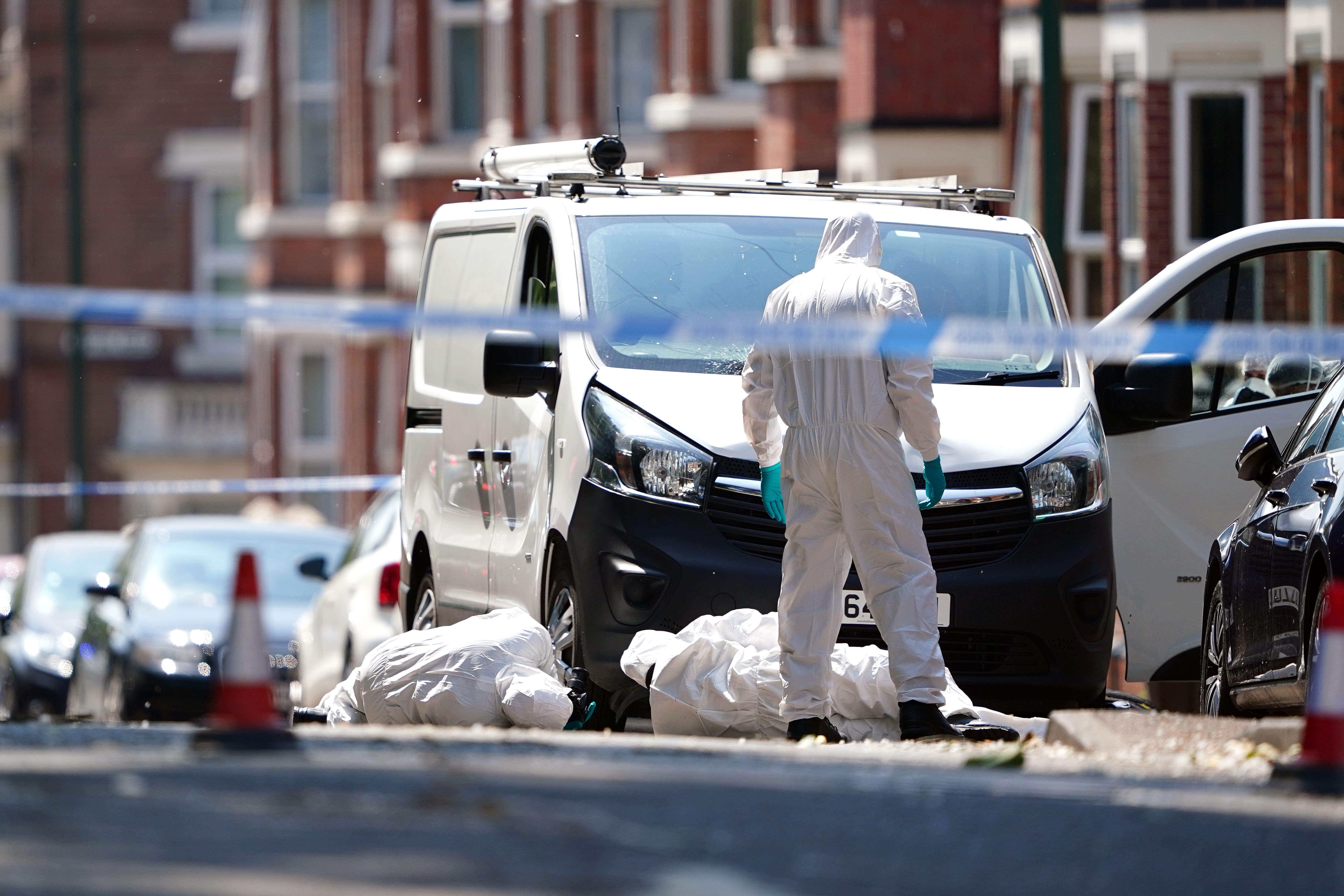 Forensics officers searched a white van on the corner of Maples Street that was allegedly used in the attacks