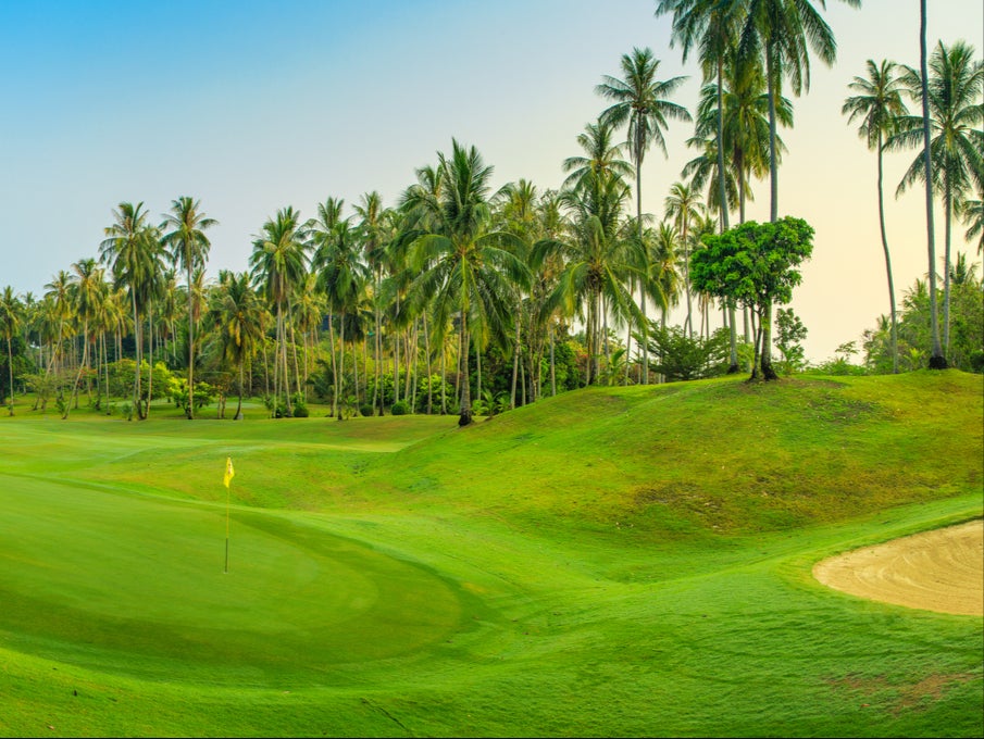 Lush green palms line the holes of Santiburi Samui Country Club