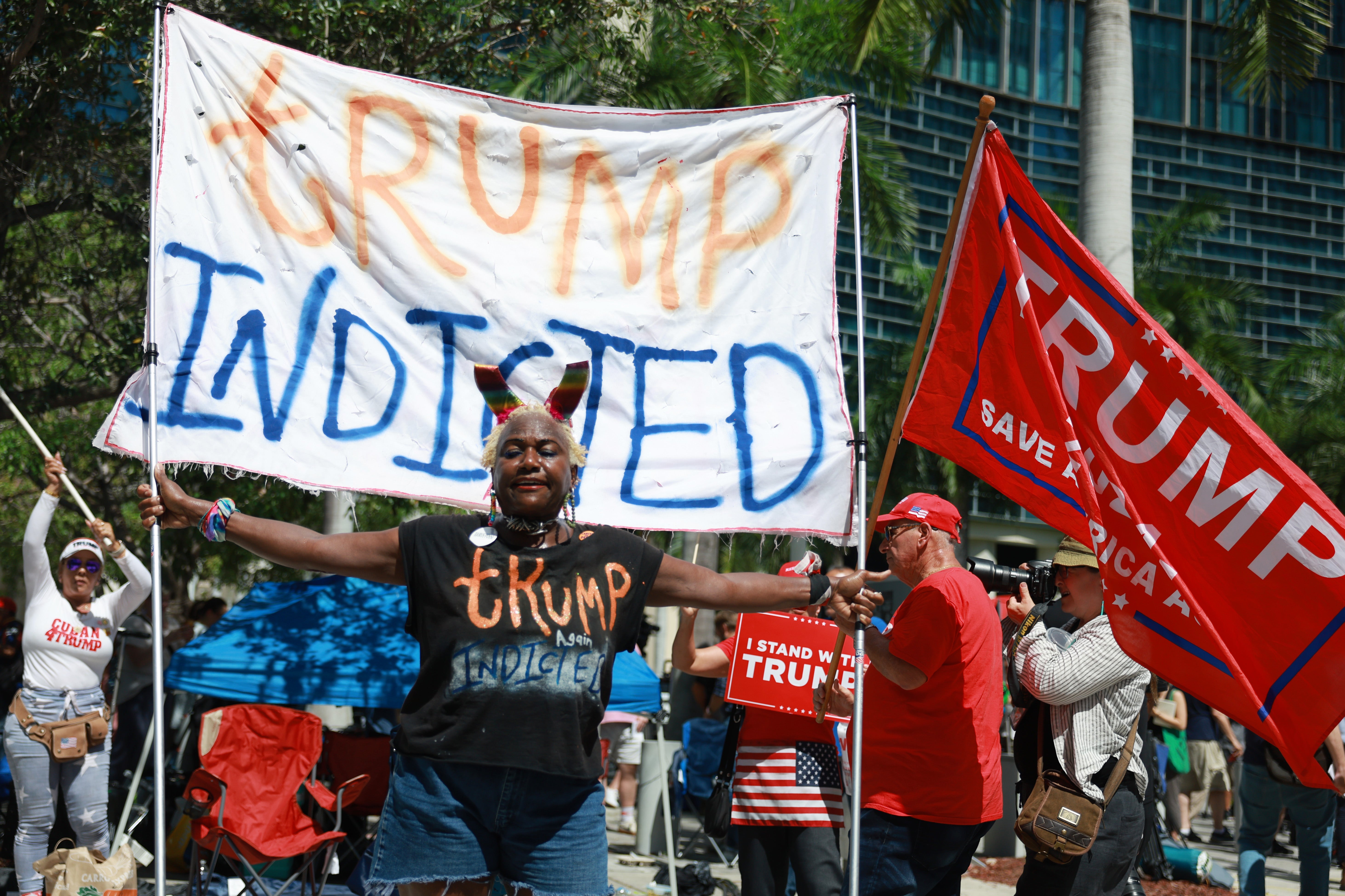 Vocal Trump opponent Nabine Seiler holds a sign that reads "Trump Indicted Again" outside the Wilkie D. Ferguson Jr. United States Federal Courthouse