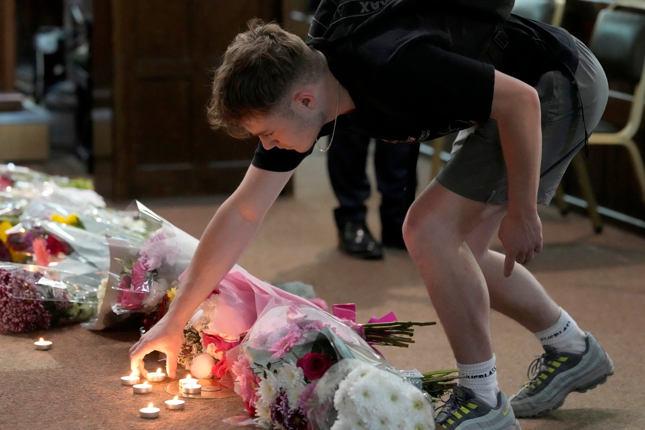 Friends of the victims brought flowers to a vigil