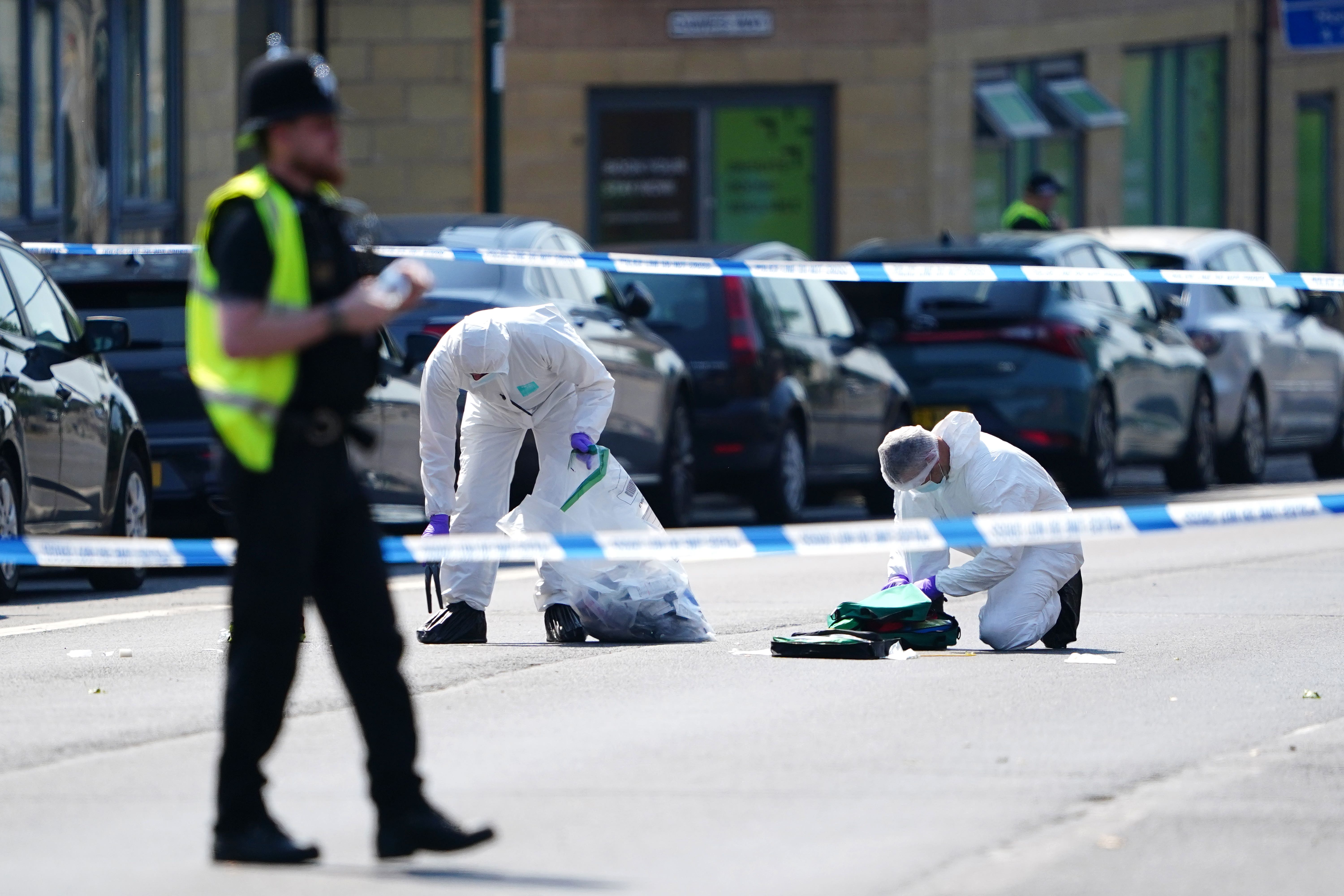 Police forensics officers on Ilkeston Road, Nottingham, following the attacks on Tuesday morning