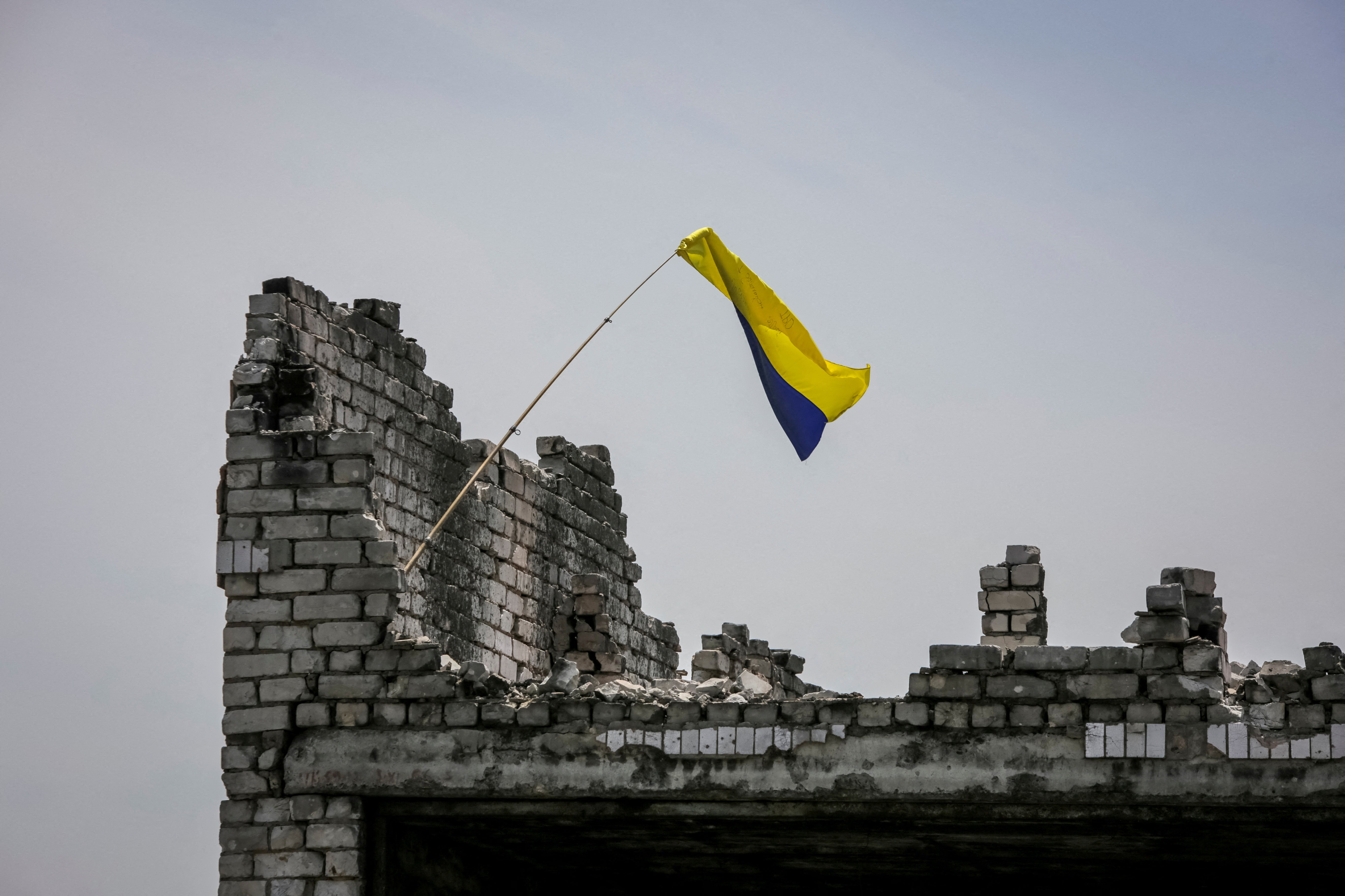 The Ukrainian national flag is seen flying in the newly-liberated village Neskuchne in Donetsk